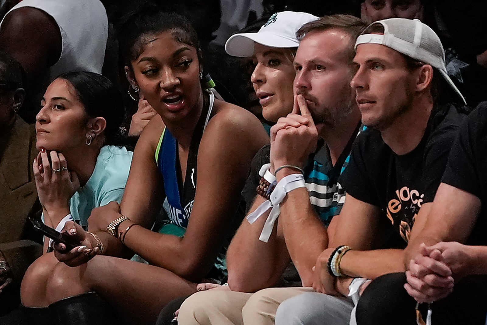 Angel Reese, second from left, watches play between the New York Liberty and the Minnesota Lynx during Game 5 of the WNBA basketball final series, Sunday, Oct. 20, 2024, in New York. (AP Photo/Pamela Smith)