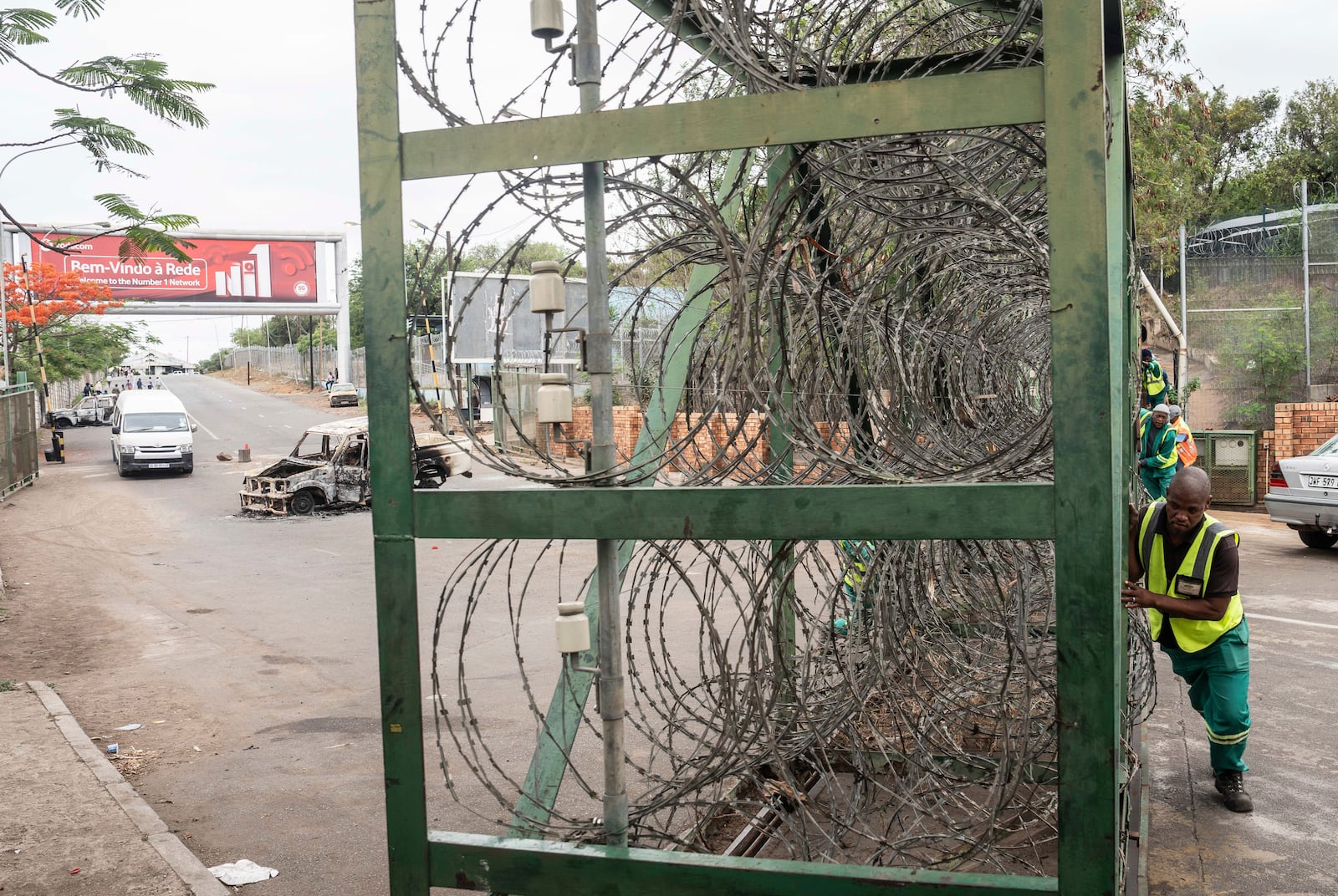 A worker closes the border crossing to Mozambique, in Lebombo, South Africa, Thursday, Nov. 7, 2024. South Africa closed its border with Mozambique shortly after opening it on Thursday as post-election violence in the neighboring country escalated. (AP Photo)