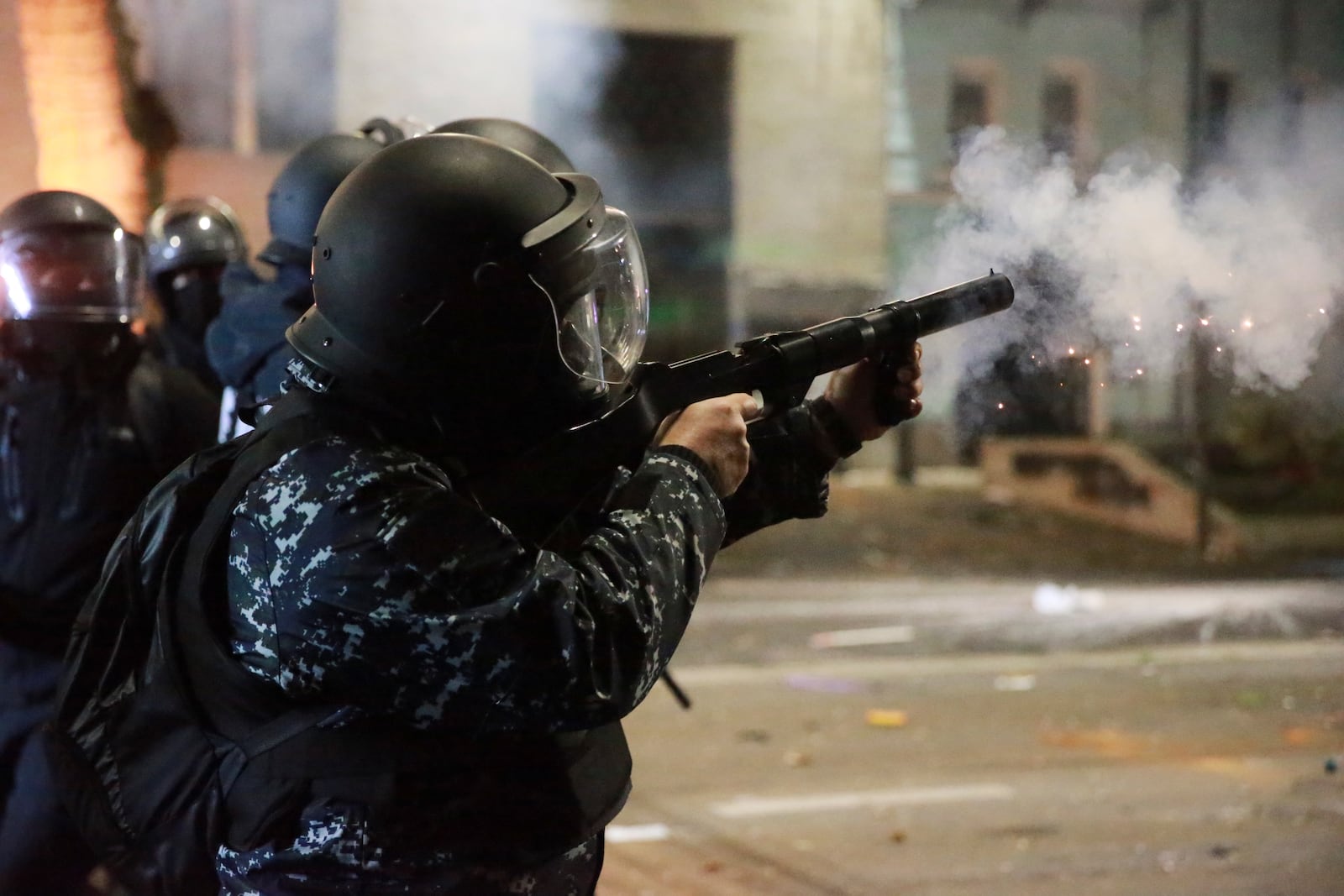 A police officer launches tear gas towards protesters rallying against the government's decision to suspend negotiations on joining the European Union in Tbilisi, Georgia, early Tuesday, Dec. 3, 2024. (AP Photo/Zurab Tsertsvadze)