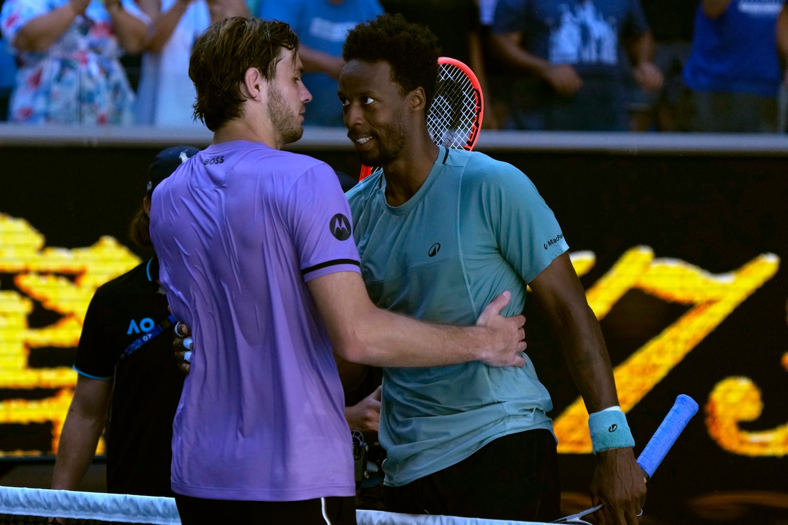 Gael Monfils, right, of France is congratulated by Taylor Fritz of the U.S. following their third round match at the Australian Open tennis championship in Melbourne, Australia, Saturday, Jan. 18, 2025. (AP Photo/Manish Swarup)