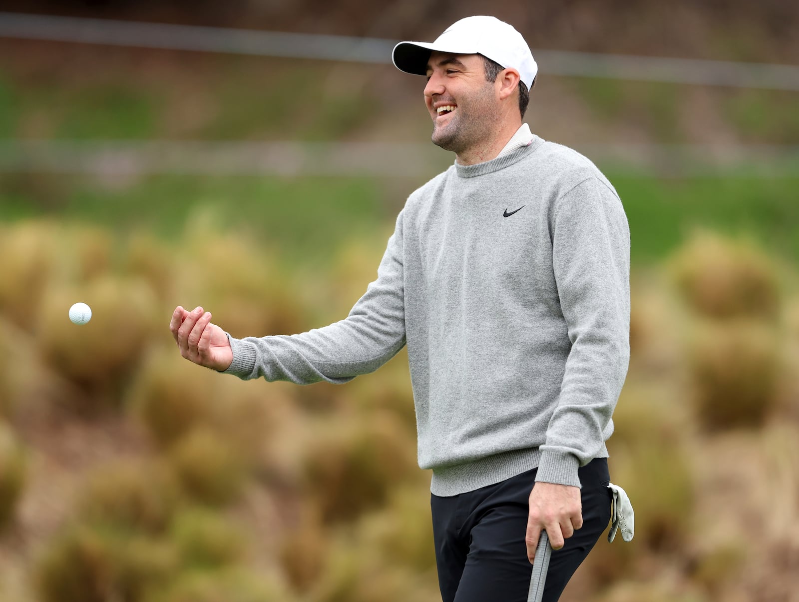 Scottie Scheffler tosses a ball to his caddie during AT&T Pebble Beach Pro-Am practice round at Spyglass Hill in Pebble Beach, Calif., on Wednesday, Jan. 29, 2025. (Scott Strazzante/San Francisco Chronicle via AP)/San Francisco Chronicle via AP)