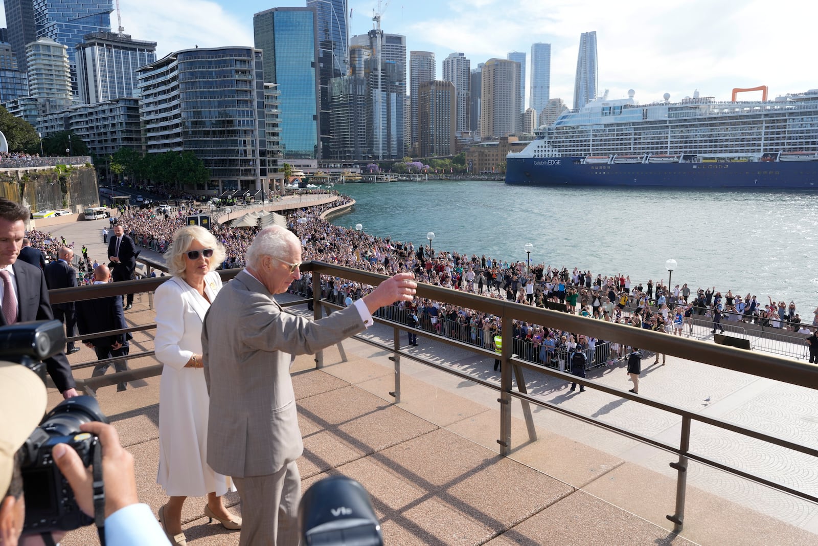 Britain's King Charles III, right, waves to the crowd beside Queen Camilla during their visit to the Sydney Opera House in Sydney, Australia, Tuesday, Oct. 22, 2024. (AP Photo/Mark Baker, Pool)