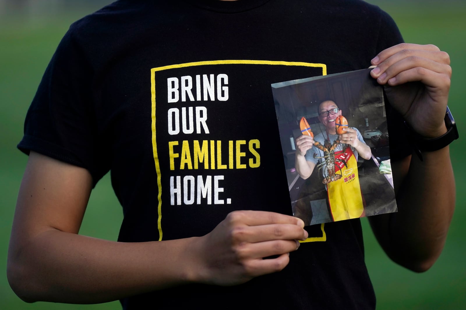 FILE - Harrison Li holds a photo of his father, Kai Li, as he poses for a photo, Tuesday, Jan. 23, 2024, in Palo Alto, Calif. (AP Photo/Jeff Chiu)