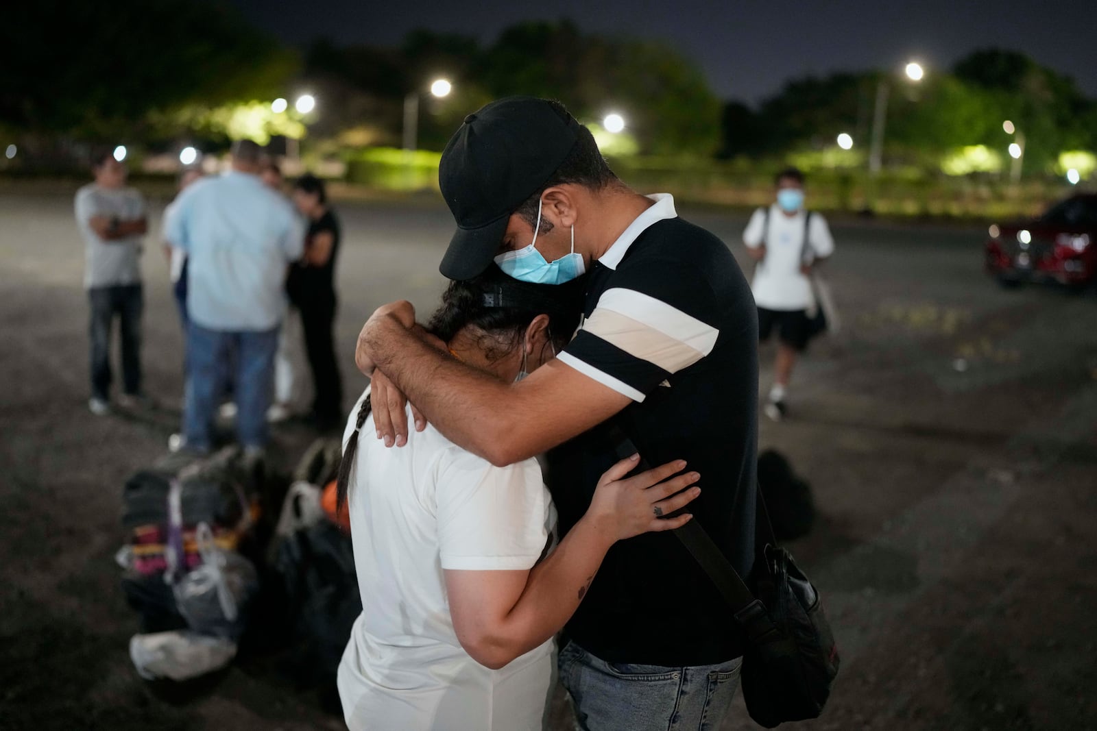 Migrants who were held in a temporary Panamanian immigration shelter after being deported from the U.S. embraced upon arriving in Panama City on Saturday, March 8, 2025, after authorities gave them 30 days to leave the country. (AP Photo/Matias Delacroix)