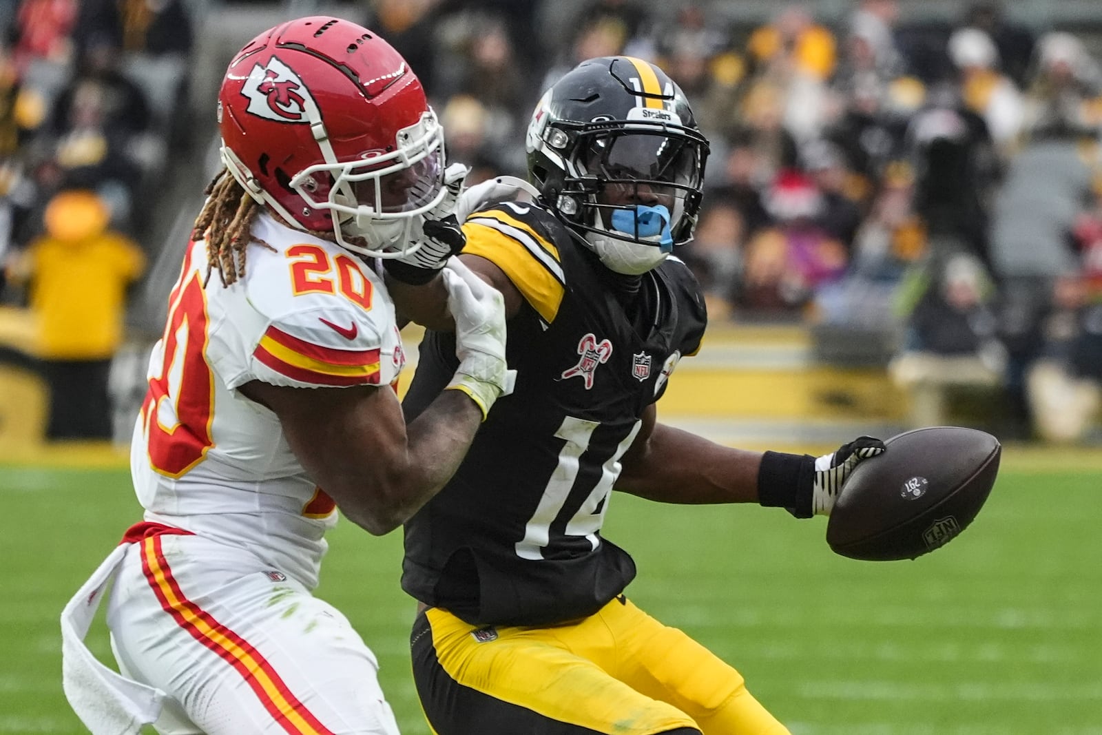 Kansas City Chiefs safety Justin Reid (20) hits Pittsburgh Steelers wide receiver George Pickens (14) during the second half of an NFL football game, Wednesday, Dec. 25, 2024, in Pittsburgh. (AP Photo/Gene J. Puskar)