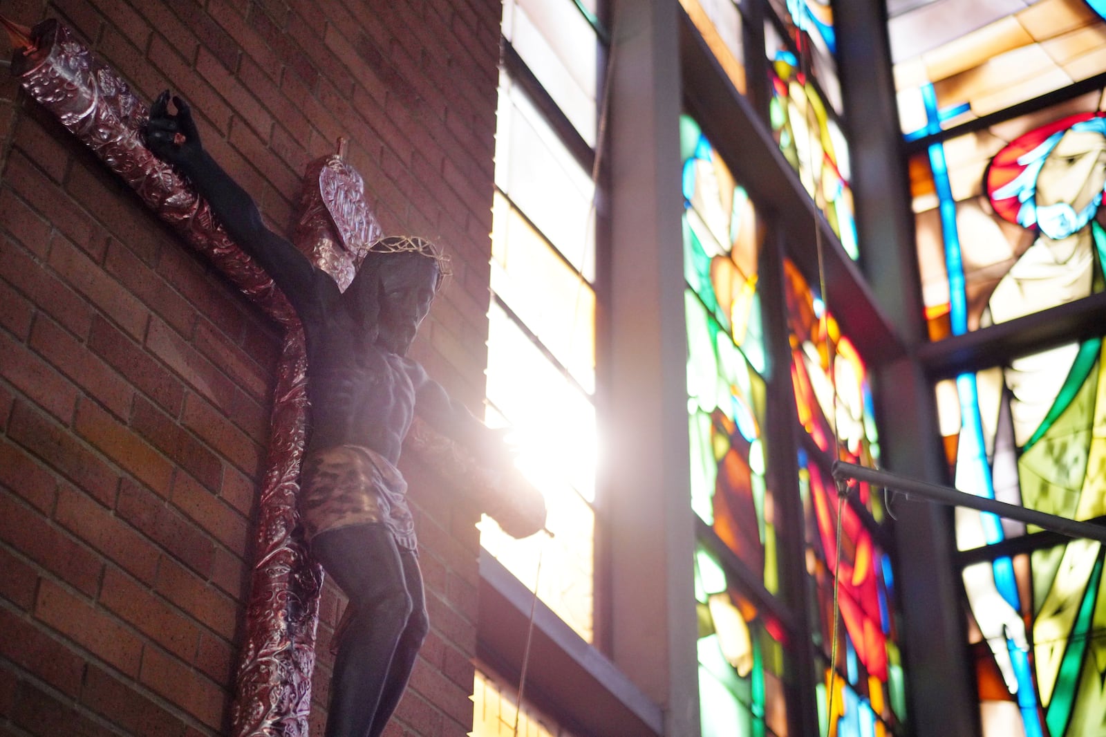 A reproduction of the "Cristo Negro de Esquipulas," a representation of Christ on the cross widely venerated in Guatemala, hangs in the entryway of St. Mary's Catholic Church in Worthington, Minn., on Sunday, Oct. 20, 2024. (AP Photo/Jessie Wardarski)