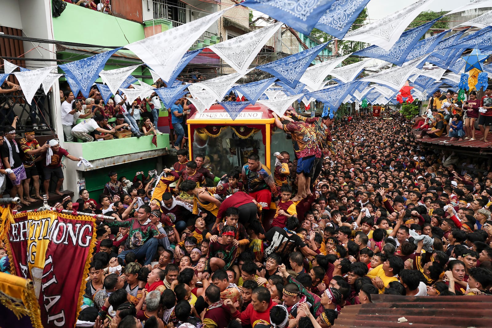 Devotees pull a glass-covered carriage carrying the image of Jesus Nazareno during its annual procession in Manila, Philippines Thursday, Jan. 9, 2025. (AP Photo/Basilio Sepe)