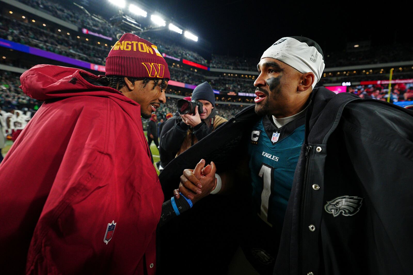 Washington Commanders quarterback Jayden Daniels, left, and Philadelphia Eagles quarterback Jalen Hurts shake hands after the NFC Championship NFL football game, Sunday, Jan. 26, 2025, in Philadelphia. (AP Photo/Derik Hamilton)