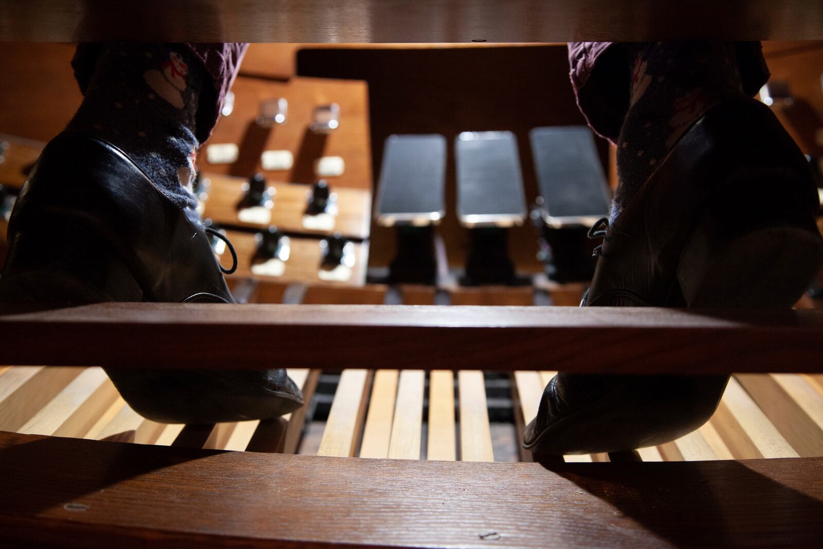 The feet of organist Colin MacKnight rest between notes, Tuesday, Jan. 21, 2025, at Trinity Episcopal Cathedral in Little Rock, Ark., where he rehearses for his upcoming weekly concert series featuring the works of Johann Sebastian Bach. (AP Photo/Katie Adkins)