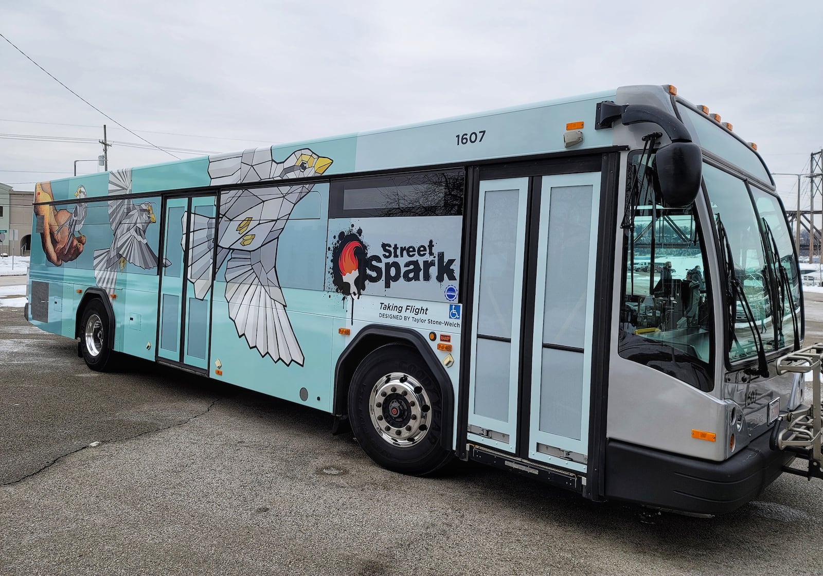 Three Butler County Regional Transit Authority buses have been wrapped in vinyl displaying StreetSpark murals that have been painted around Hamilton. This bus features the "Taking Flight" mural by artist Taylor Stone-Welch. NICK GRAHAM / STAFF