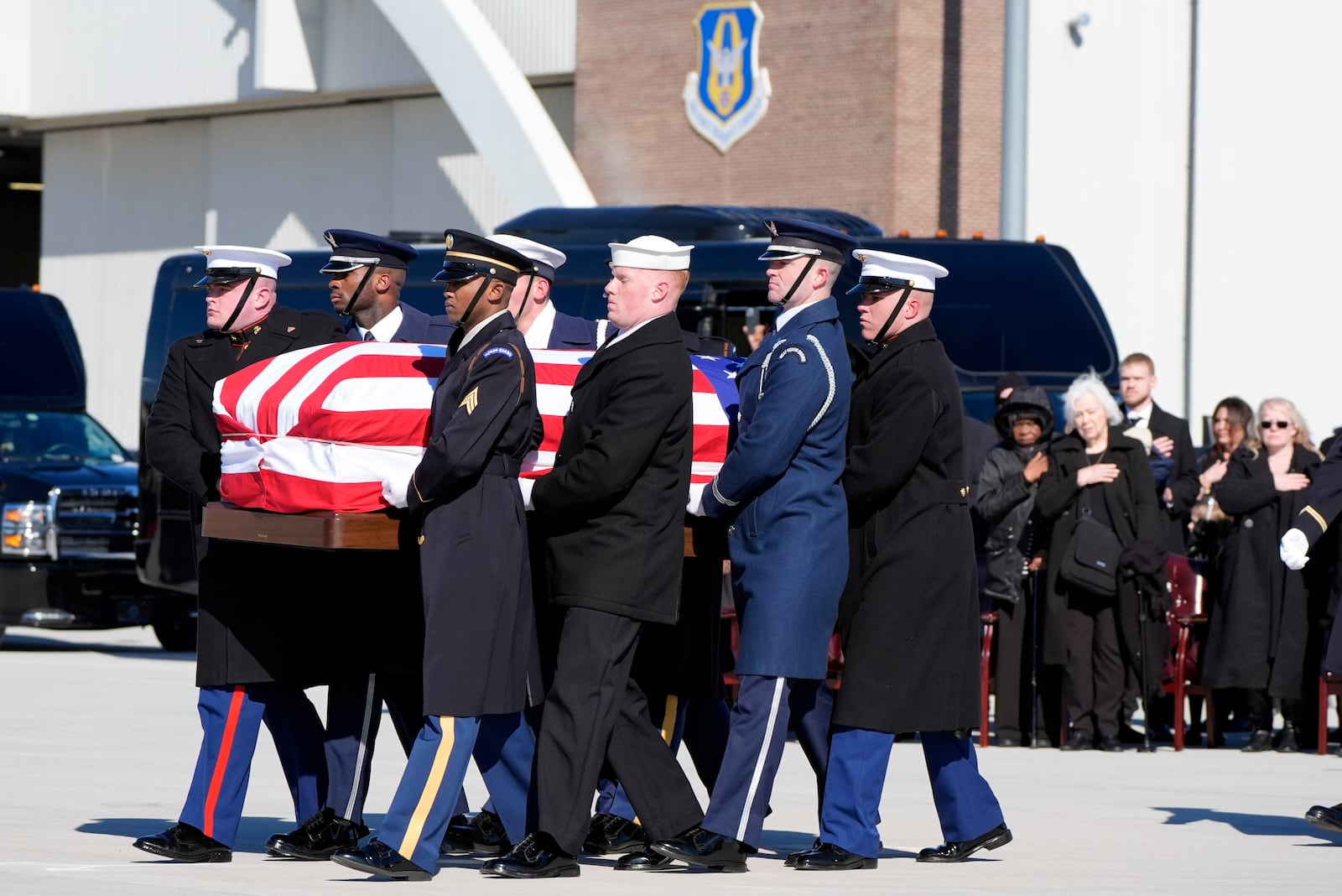 A joint forces military body bearer team moves flag-draped casket of former President Jimmy Carter to Special Air Mission 39 at Dobbins Air Reserve Base in Marietta, Ga., Tuesday, Jan. 7, 2025. Carter died Dec. 29 at the age of 100. (AP Photo/Alex Brandon, Pool)