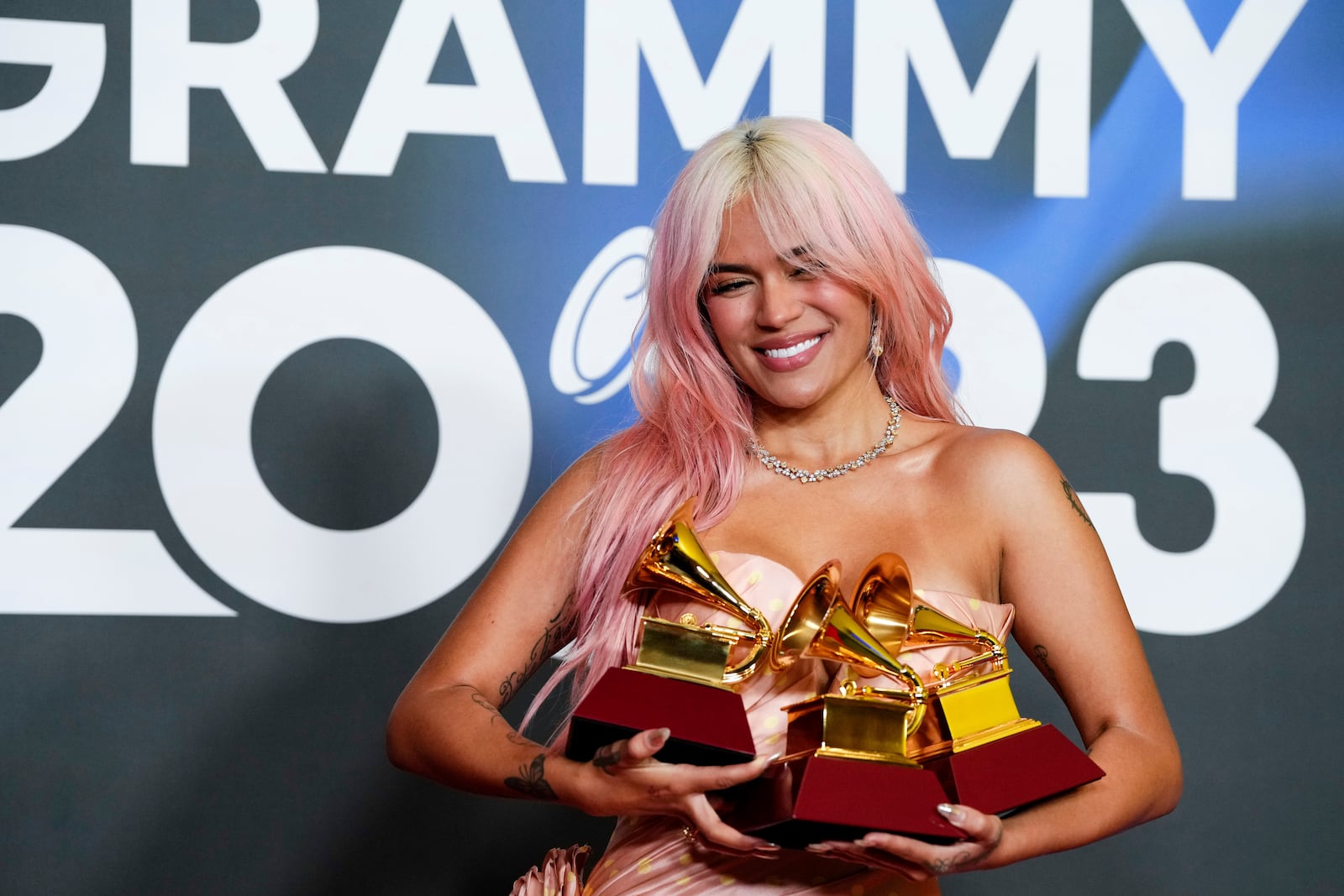 FILE - Karol G poses with her Latin Grammy gramophone-shaped trophies for best urban album; album of the year; and best urban fusion/performance, during the 24th Annual Latin Grammy Awards ceremony, in Seville, Spain, Nov. 16, 2023. (Photo by Jose Breton/Invision/AP File)