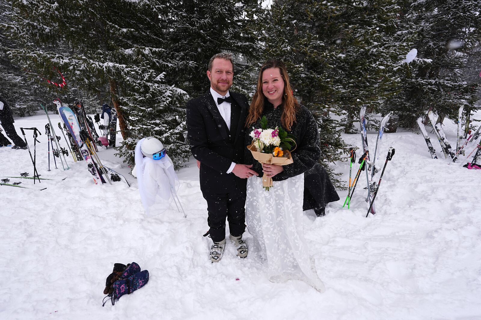 Alex Frank and Allie Bamber of Arvada, Colo., pose for a photo before exchanging vows at the 35th annual Marry Me & Ski for Free Valentine's Day mountaintop matrimony ceremony, Friday, Feb. 14, 2025, at Loveland Ski Area, Colo. (AP Photo/David Zalubowski)