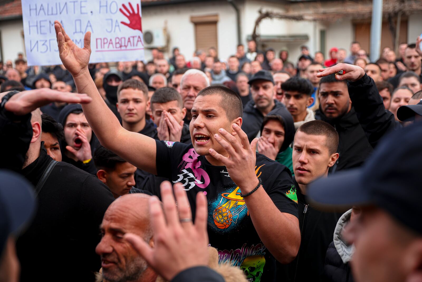 People argue with policemen, outside the home of the owner of a nightclub that was the scene of a massive fire, after a vigil for the victims in the town of Kocani, North Macedonia, Monday, March 17, 2025. (AP Photo/Armin Durgut)