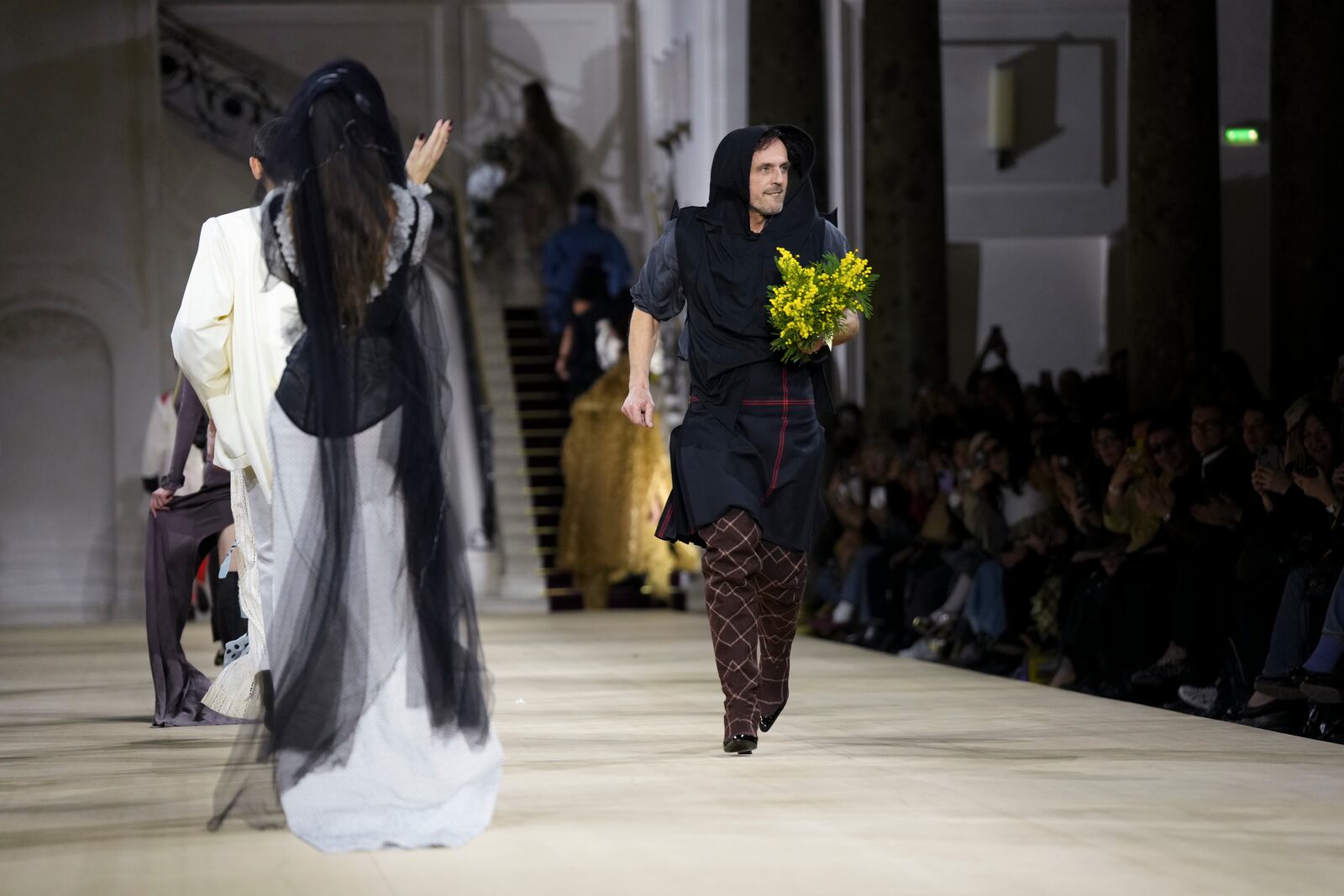 Designer Andreas Kronthaler accepts applause after the Vivienne Westwood Fall/Winter 2025-2026 Womenswear collection presented in Paris, Saturday, March 8, 2025. (Photo by Scott A Garfitt/Invision/AP)