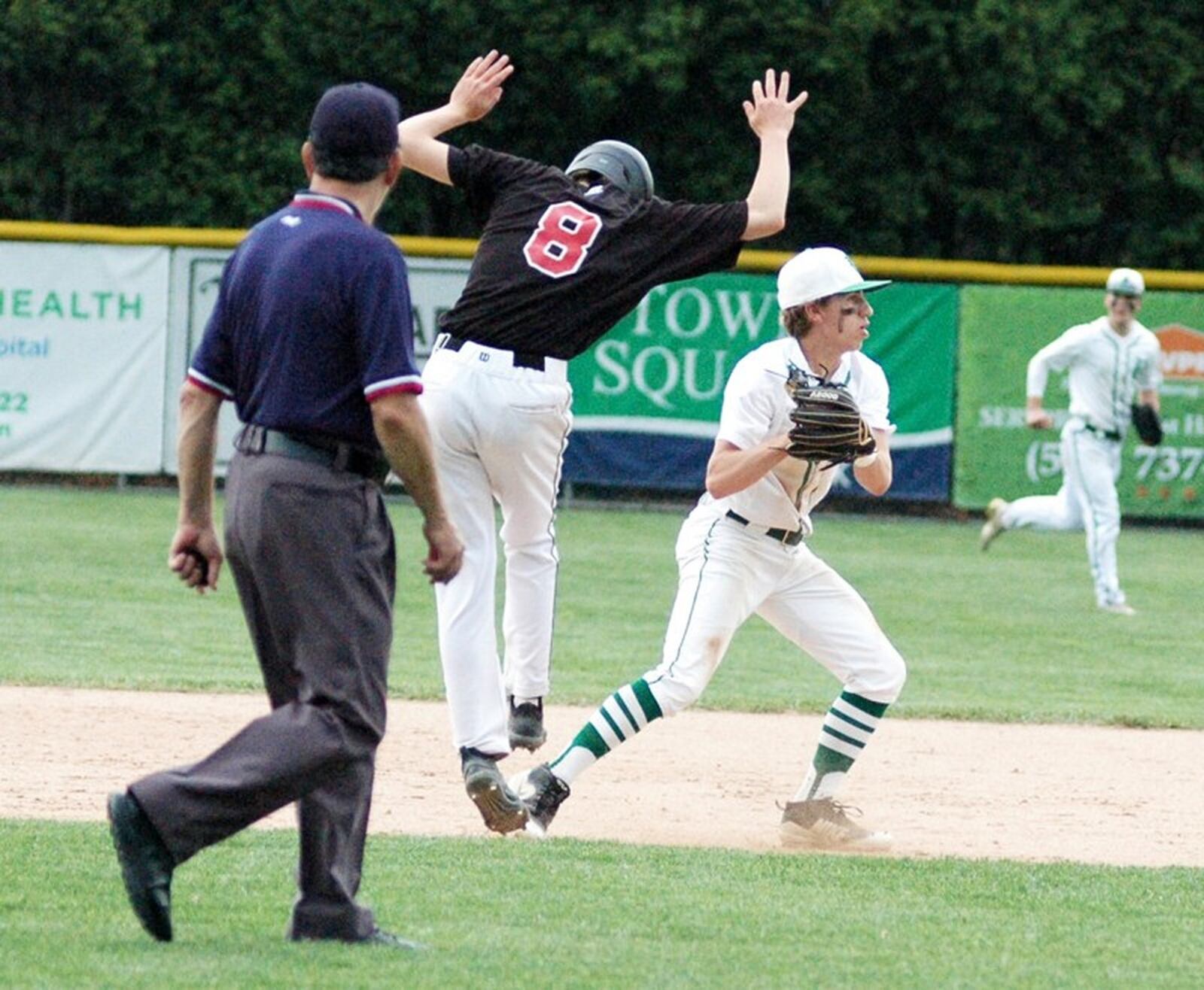 Badin second baseman A.J. Enginger tags Oak Hills runner Austin Dennis (8) and then throws to first base for a 4-3 double play May 16 during a Division I sectional baseball game at Alumni Field in Joyce Park. Host Badin won 11-0 in five innings. RICK CASSANO/STAFF