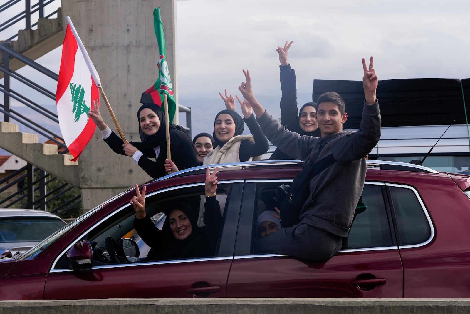 Displaced residents celebrate as they return to their villages following a ceasefire between Israel and Hezbollah that went into effect on Wednesday, Nov. 27, 2024, in Ablah, eastern Lebanon. (AP Photo/Hassan Ammar)