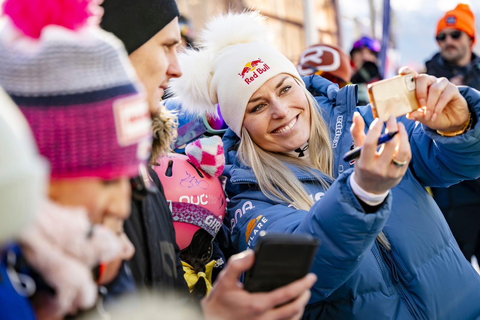 United States' Lindsey Vonn, takes a selfie in the finish area after completing an alpine ski, women's World Cup super G, in St. Moritz, Switzerland, Saturday, Dec. 21, 2024. (Jean-Christophe Bott/Keystone via AP)