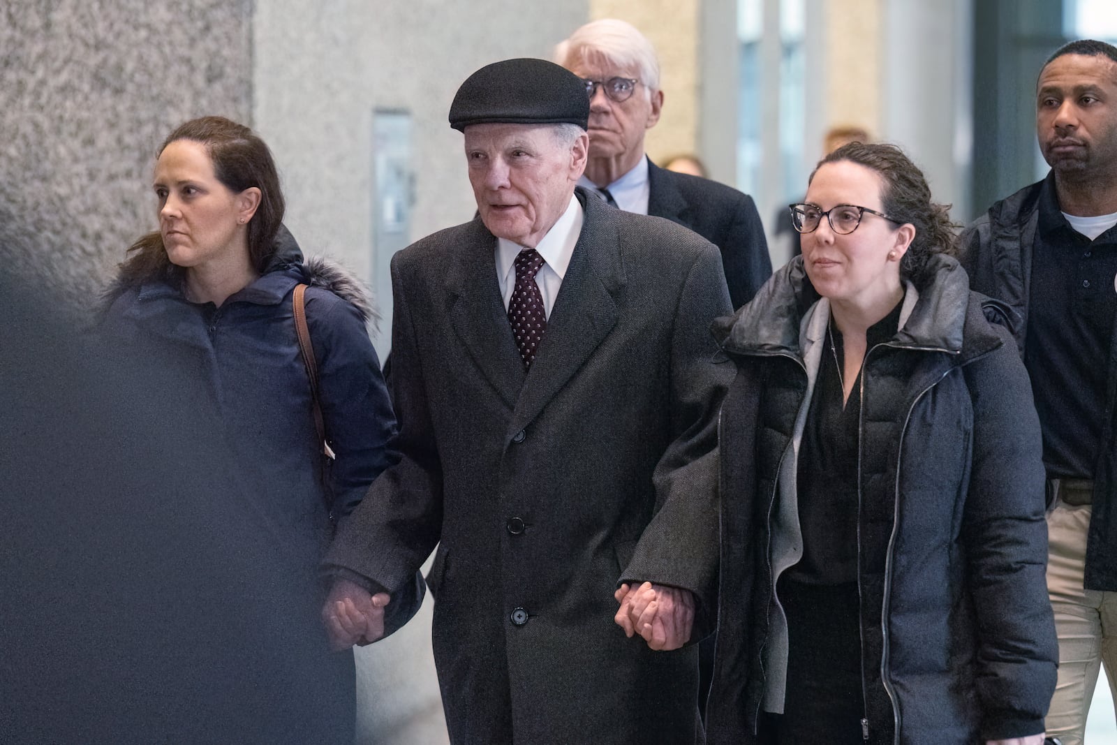 While holding hands with his daughters Nicole, left, and Tiffany, Illinois' former House Speaker Michael Madigan walks out of the Dirksen Federal Courthouse in Chicago, Wednesday, Feb. 12, 2025. (Tyler Pasciak LaRiviere/Chicago Sun-Times via AP)