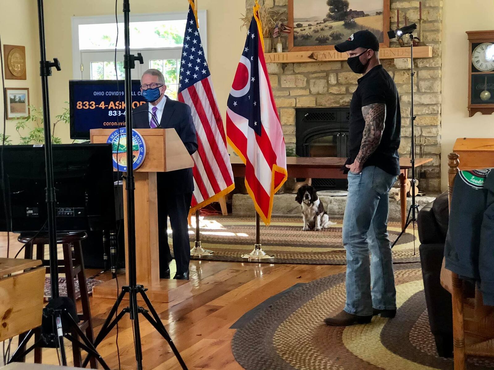 Gov. Mike DeWine and videographer Eric Porter get ready for a coronavirus press briefing to be broadcast from DeWine's Greene County farm. First Dog Dolly looks on.