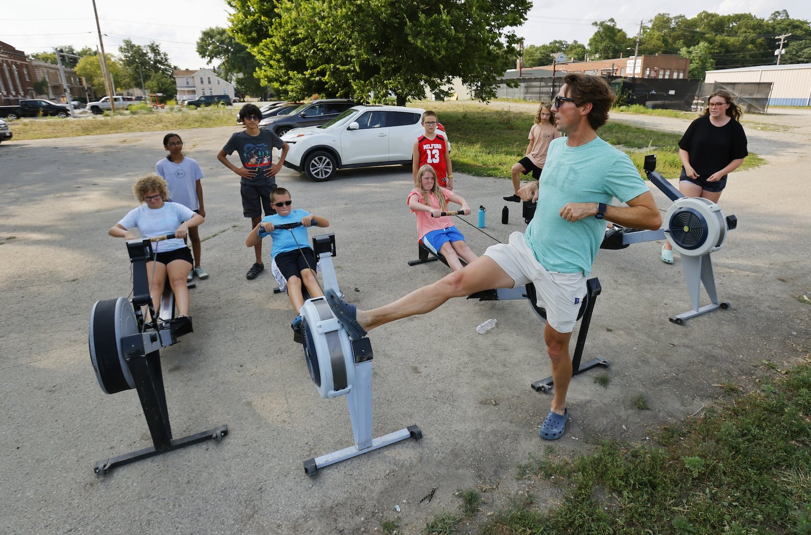 Marc Oria, head coach of Great Miami Crew, demonstrates proper rowing technique during practice Wednesday, Aug. 11, 2021 on the Great Miami River in Hamilton. NICK GRAHAM / STAFF