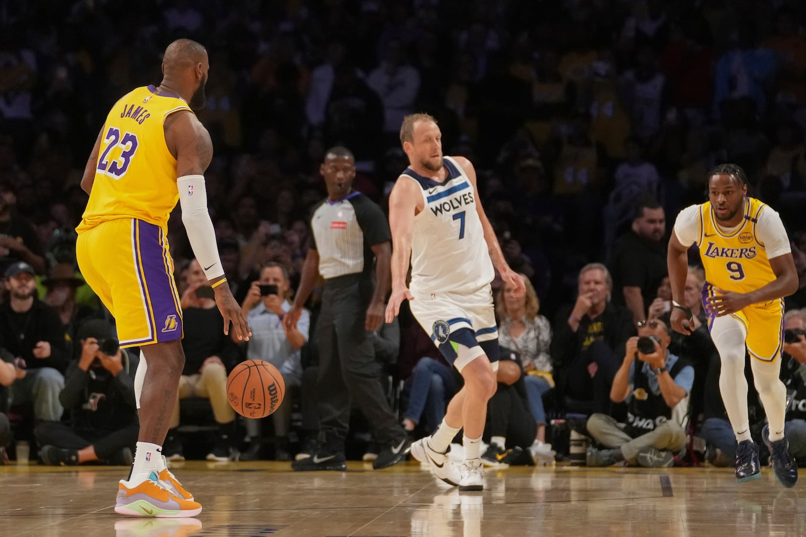 Los Angeles Lakers forward LeBron James (23) looks to pass to guard Bronny James (9) during the first half of an NBA basketball game against the Minnesota Timberwolves, Tuesday, Oct. 22, 2024, in Los Angeles. (AP Photo/Eric Thayer)