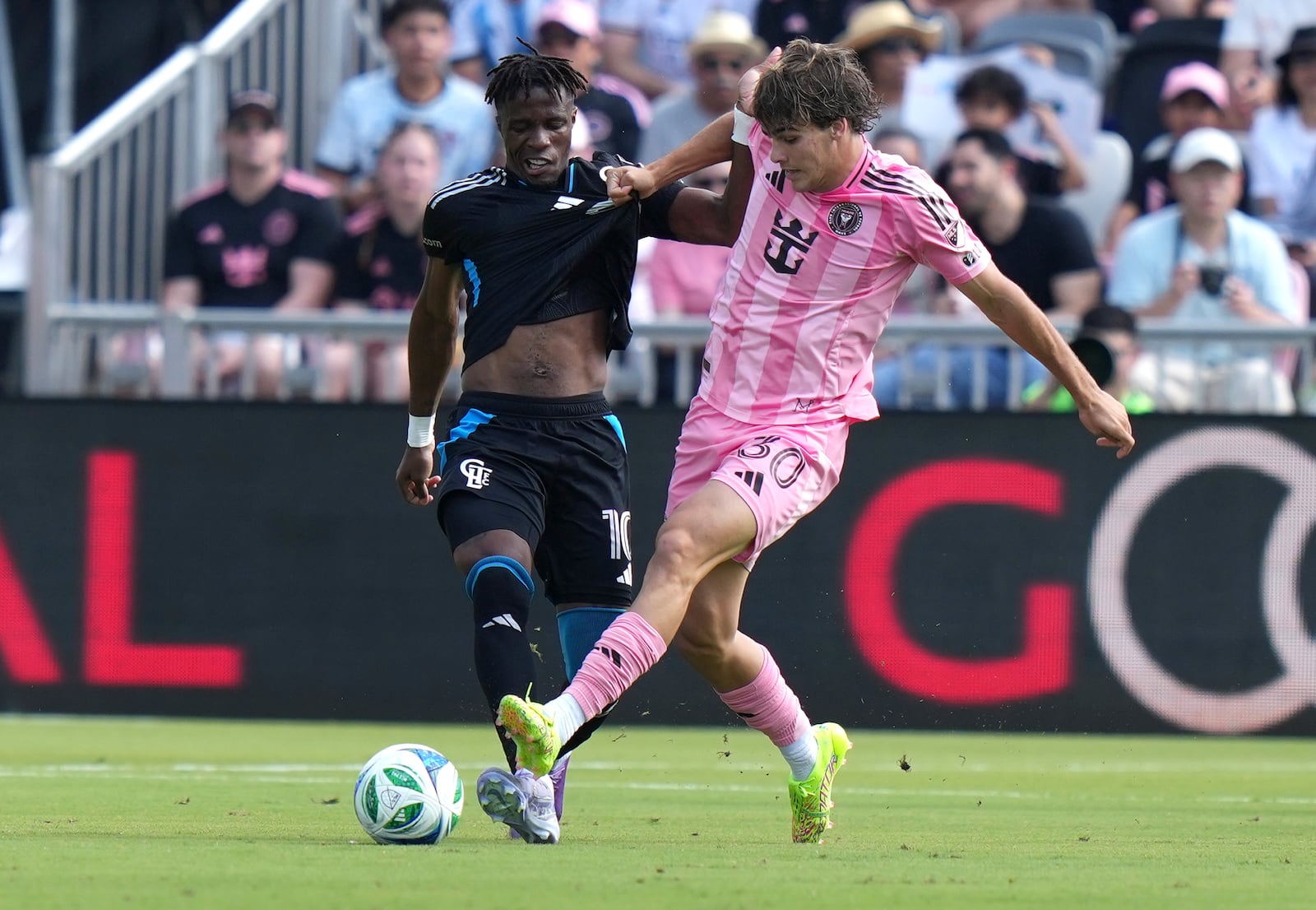 Charlotte FC forward Wilfried Zaha, left, and Inter Miami midfielder Benjamin Cremaschi (30) go for the ball during the first half of an MLS soccer match, Sunday, March 9, 2025, in Fort Lauderdale, Fla. (AP Photo/Lynne Sladky)