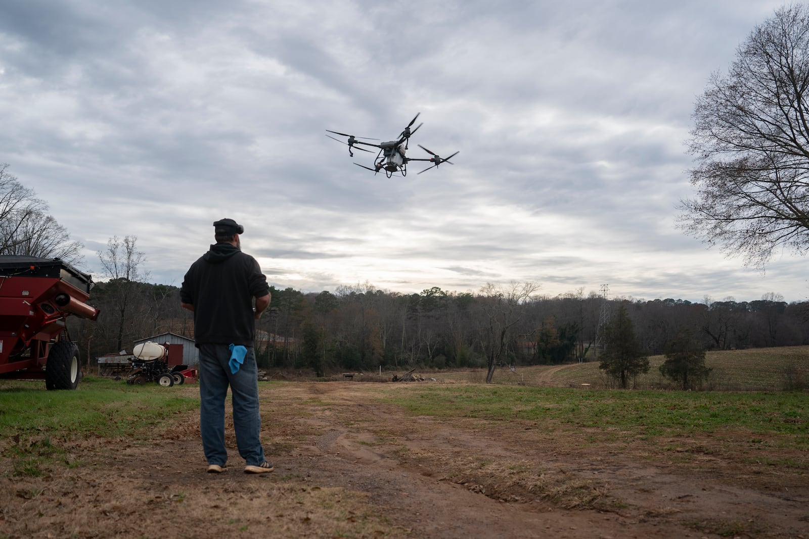 Russell Hedrick uses a DJI drone to put crop cover on his farm, Tuesday, Dec. 17, 2024, in Hickory, N.C. (AP Photo/Allison Joyce)