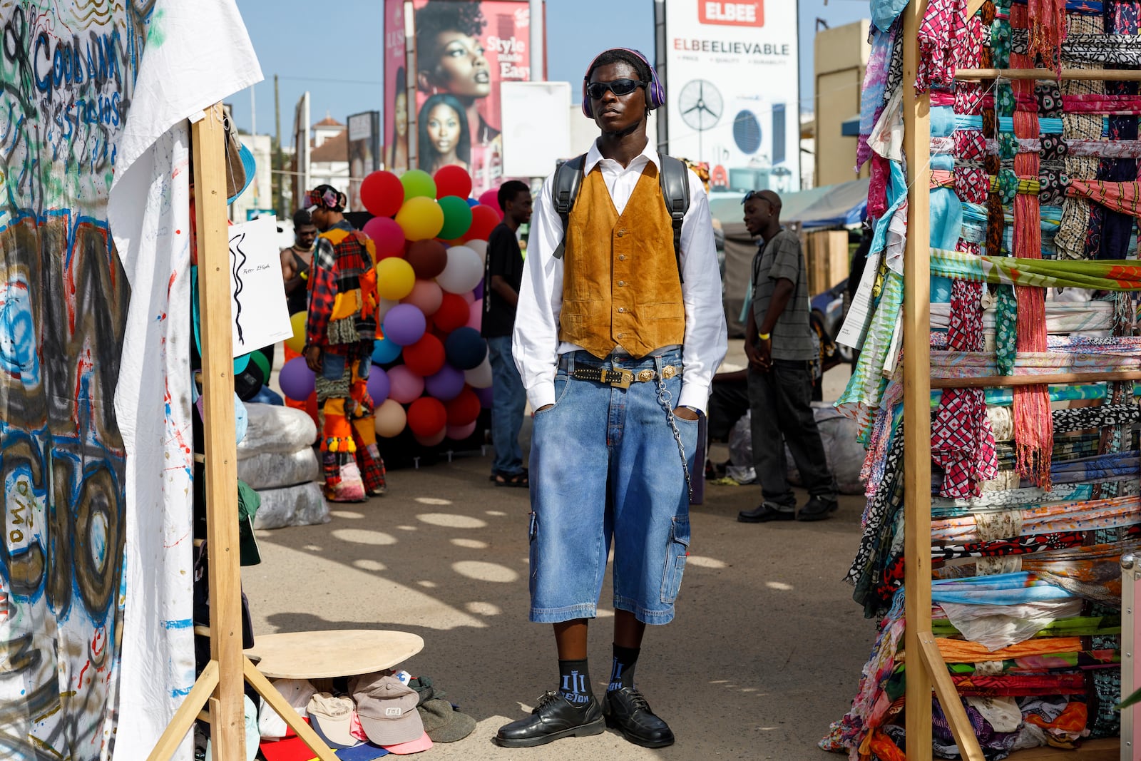 A young man dressed in a thrift outfit poses for a photograph during a thrift and an upcycle show in Accra, Ghana, Sunday, Oct. 27, 2024. (AP Photo/Misper Apawu)