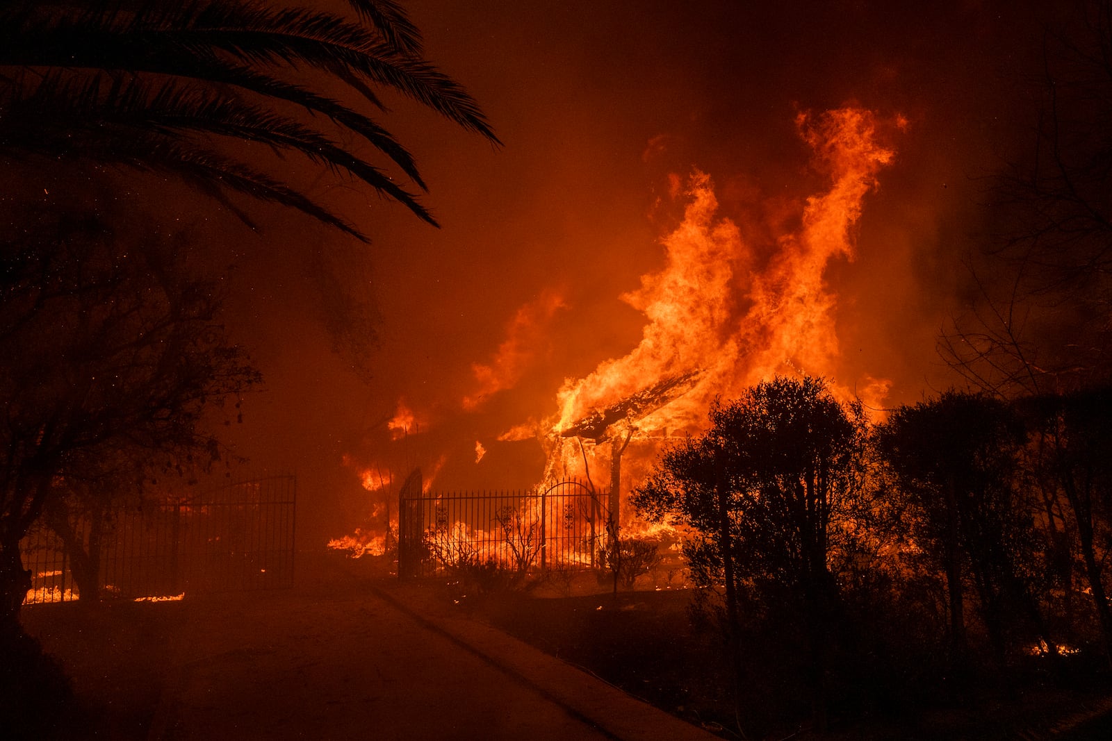 A house burns in the Eaton Fire in Altadena, Calif., Wednesday, Jan. 8, 2025. (AP Photo/Nic Coury)