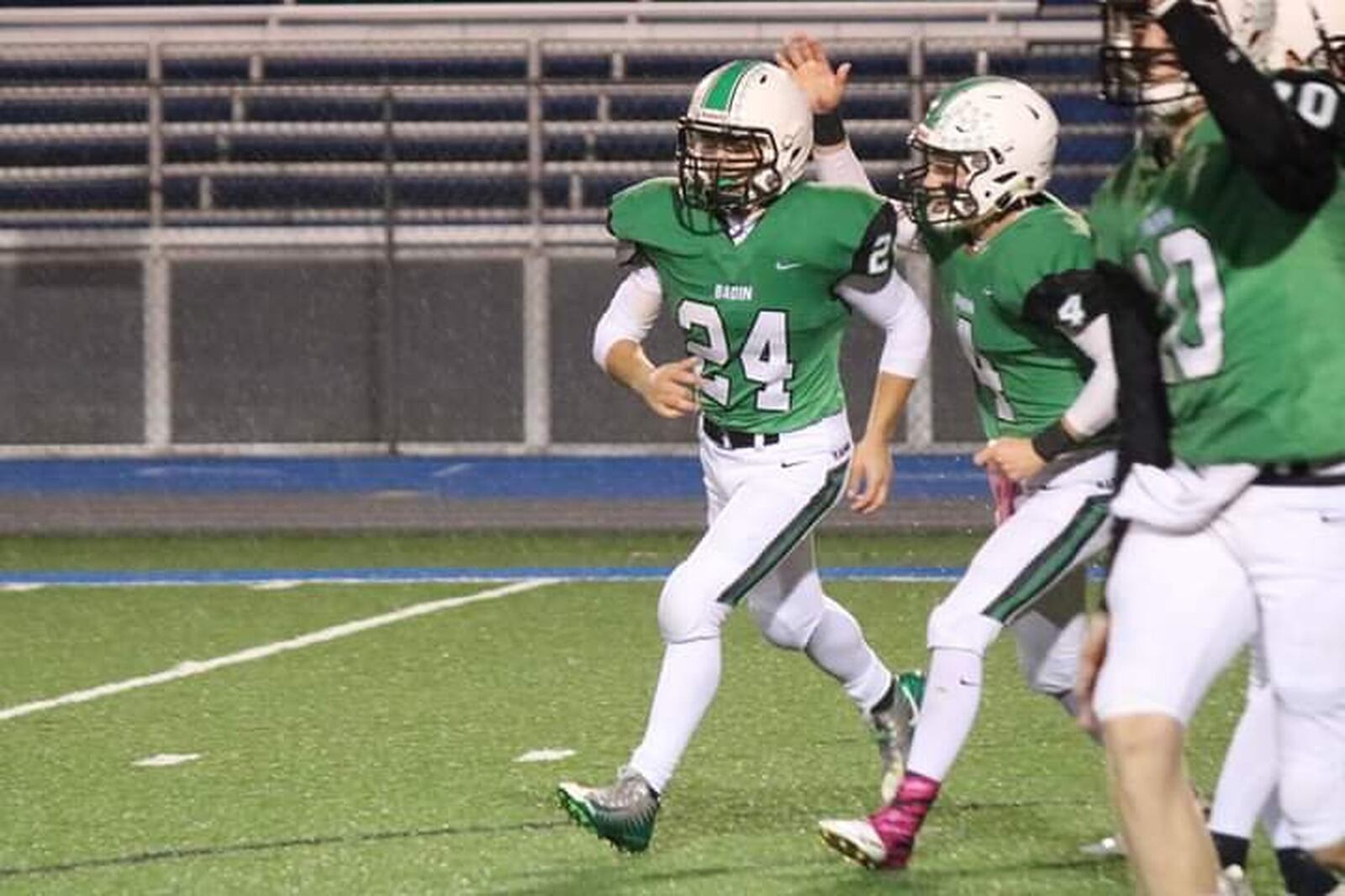 Badin’s Ben Grawe (24) is congratulated by teammate Luke Tabler after Grawe scored his first career touchdown in Friday night’s game against McNicholas at Virgil Schwarm Stadium in Hamilton. CONTRIBUTED PHOTO BY TERRI ADAMS