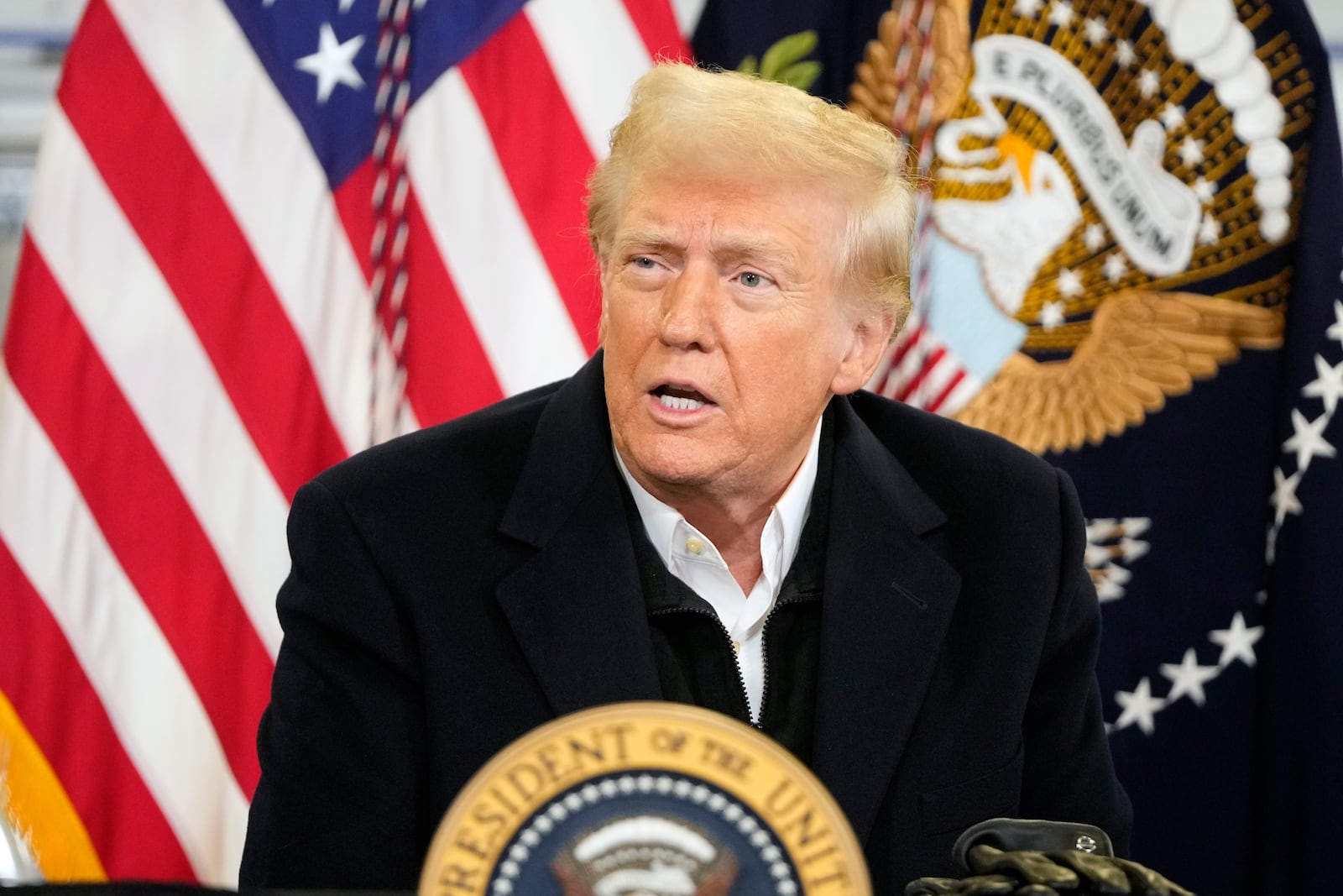 President Donald Trump is briefed on the effects of Hurricane Helene at Asheville Regional Airport in Fletcher, N.C., Friday, Jan. 24, 2025. (AP Photo/Mark Schiefelbein)