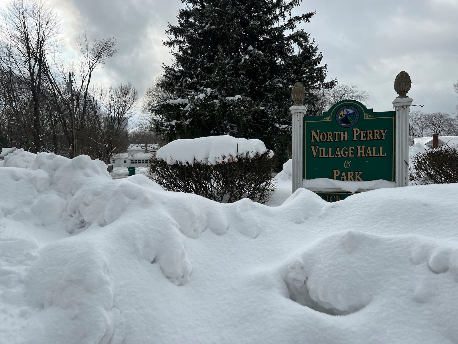 Snow covers the sign for the North Perry Village Hall in North Perry, Ohio on Tuesday, Dec. 3, 2024. (AP Photo/Patrick Aftoora-Orsagos)