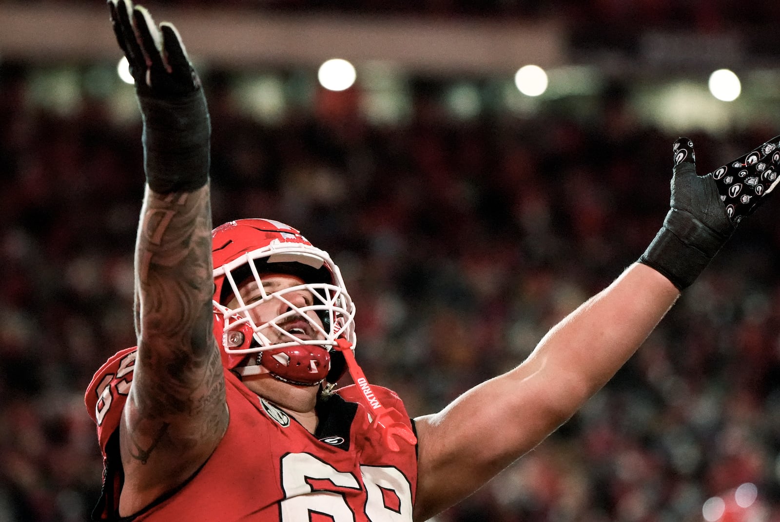 Georgia offensive lineman Tate Ratledge (69) celebrates a Georgia score against Georgia Tech during the sixth overtime of an NCAA college football game, Saturday, Nov. 30, 2024, in Athens, Ga. (AP Photo/Mike Stewart)