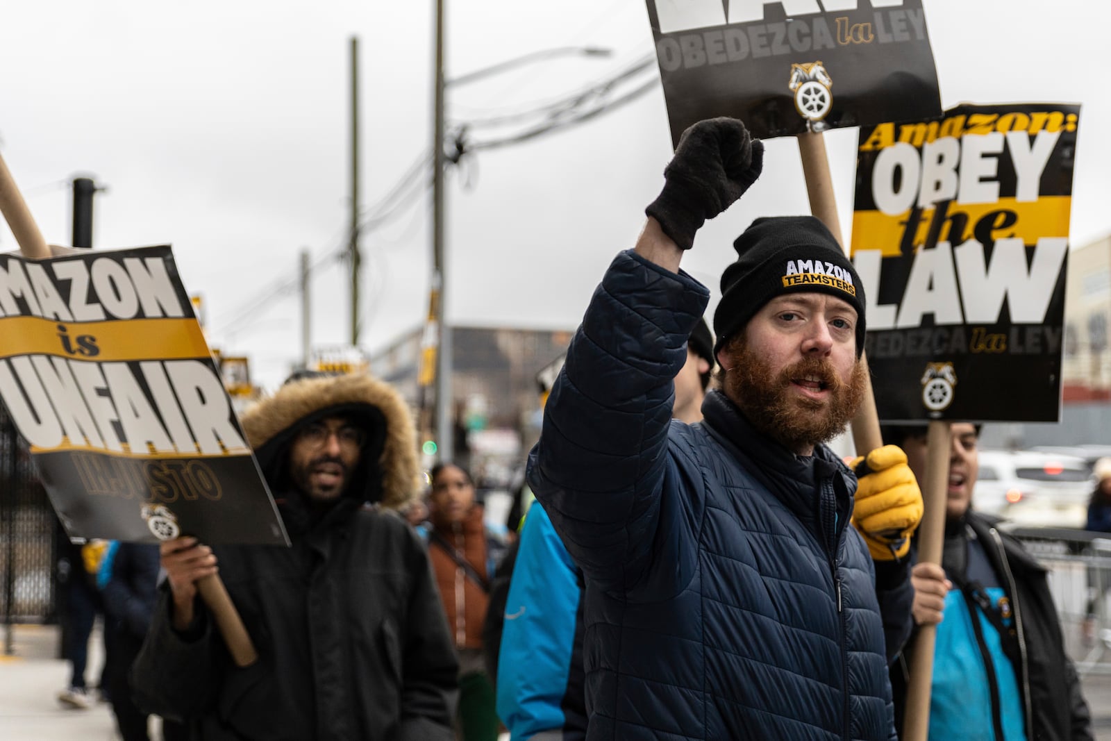 Amazon workers and members of the International Brotherhood of Teamsters picket in front of the Amazon fulfilment center in the Queens borough of in New York, on Friday, Dec. 20, 2024. (AP Photo/Stefan Jeremiah)