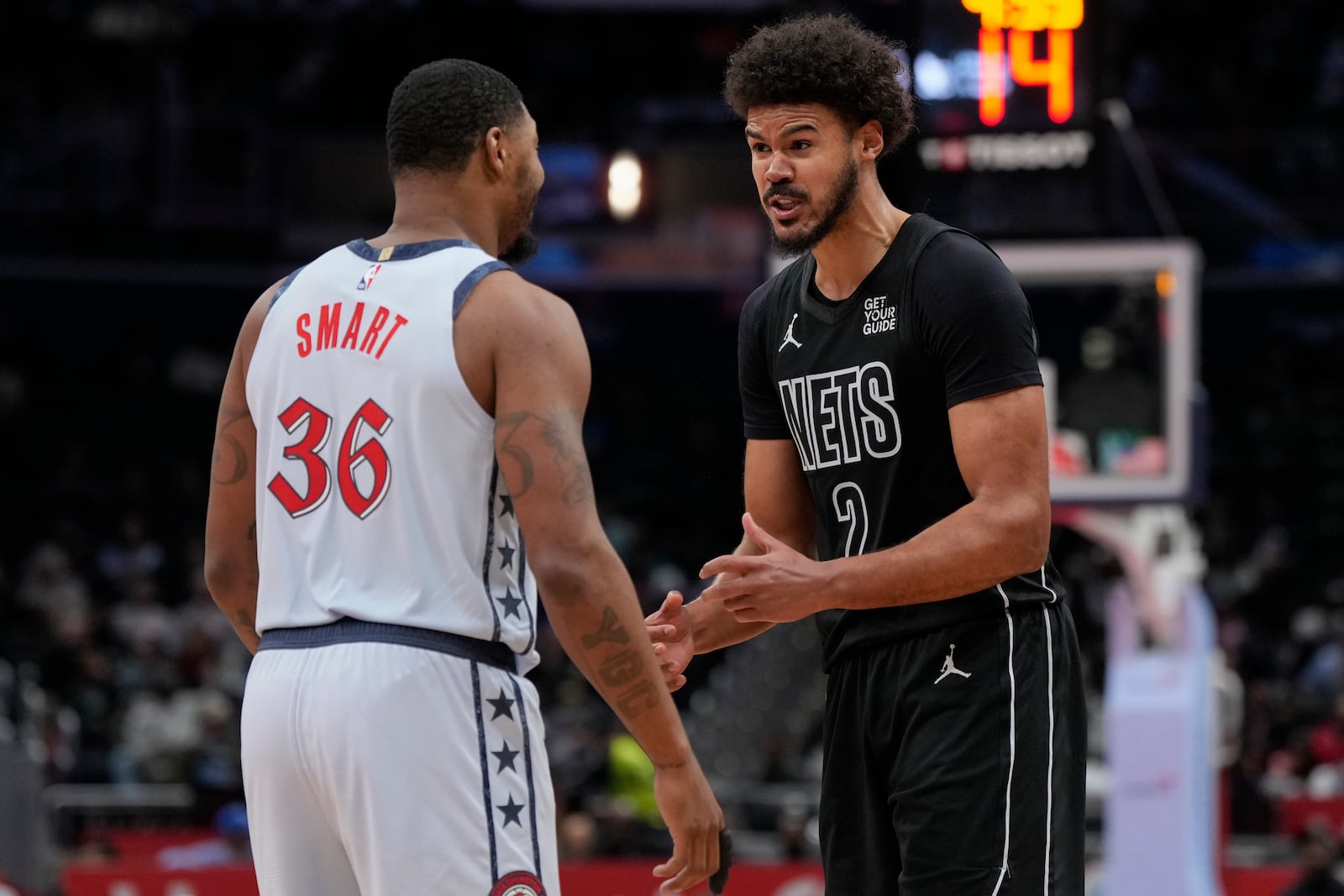 Washington Wizards guard Marcus Smart (36) and Brooklyn Nets forward Cameron Johnson (2) exchange words during the second half of an NBA basketball game, Monday, Feb. 24, 2025, in Washington. (AP Photo/Jess Rapfogel)