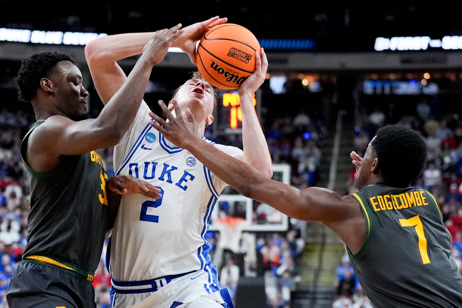 Duke forward Cooper Flagg drives to the basket between Baylor guard Jalen Celestine and guard VJ Edgecombe (7) during the first half in the second round of the NCAA college basketball tournament, Sunday, March 23, 2025, in Raleigh, N.C. (AP Photo/Chris Carlson)