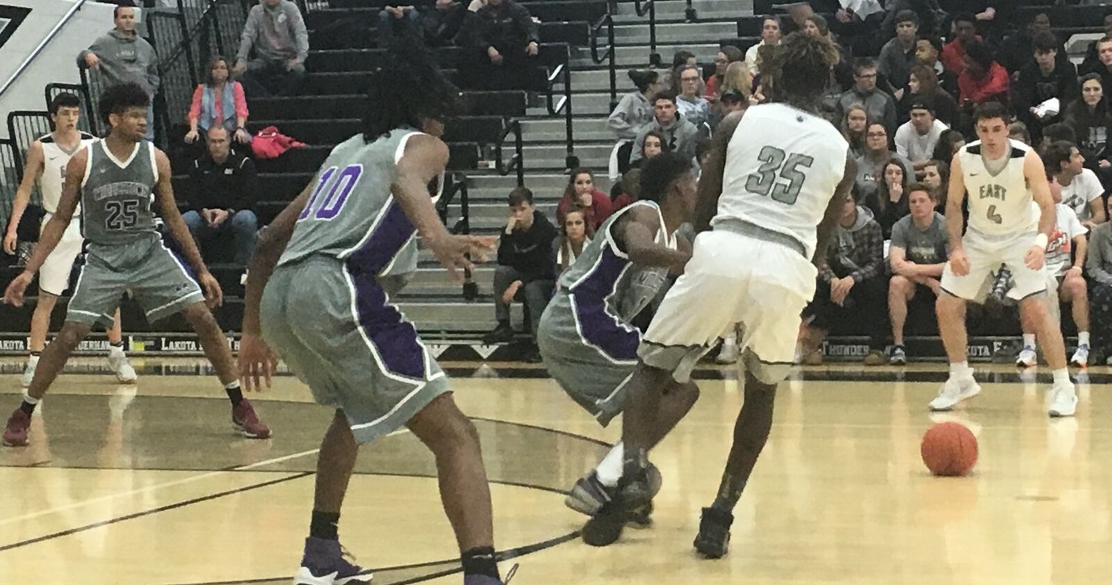 Lakota East’s Jarrett Cox (35) sends a pass toward teammate Jackson See (4) during Tuesday night’s game in Liberty Township. RICK CASSANO/STAFF