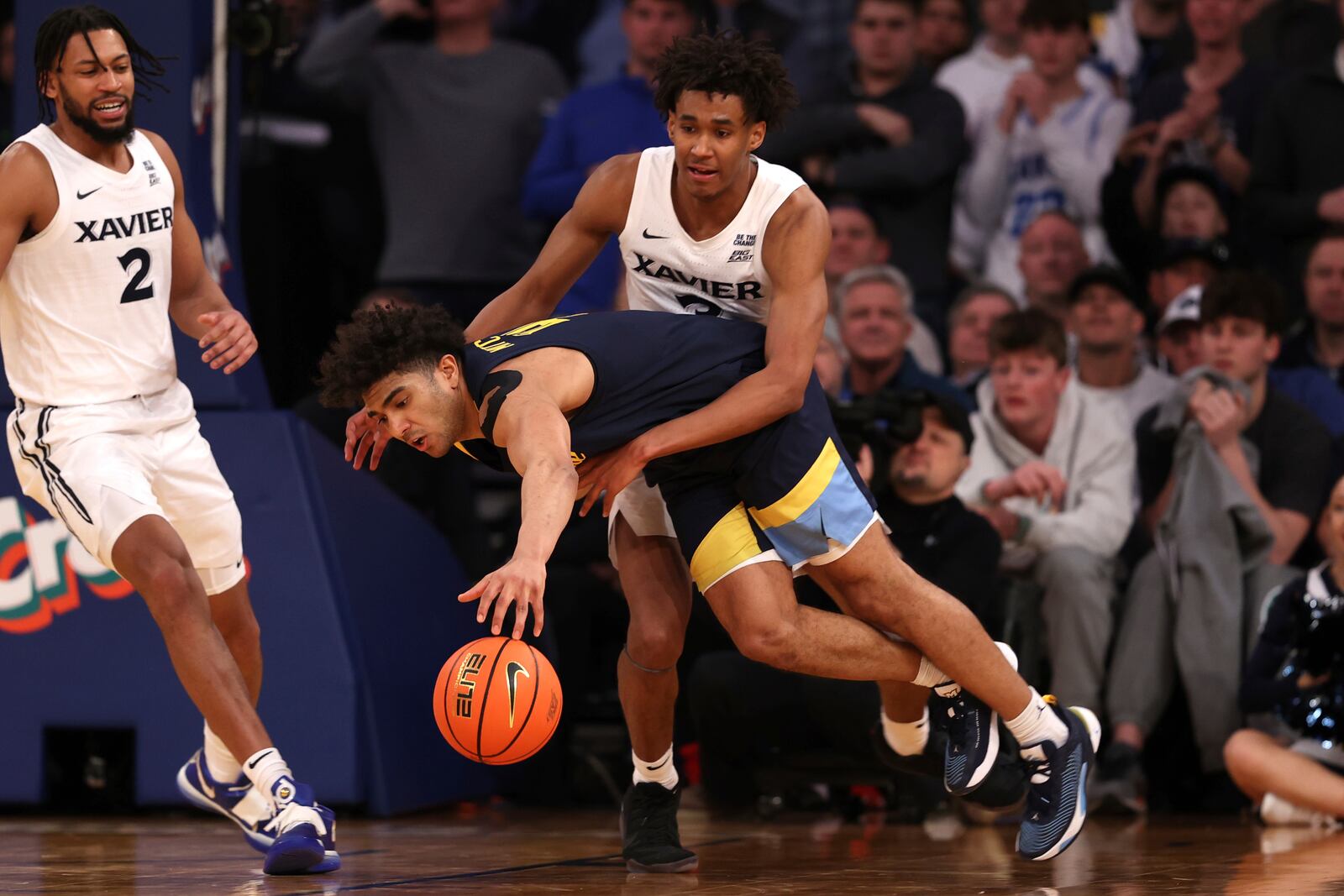 Xavier guard Dailyn Swain, right, fouls Marquette guard Stevie Mitchell, left, during the second half of an NCAA college basketball game in the quarterfinals of the Big East Conference tournament, Thursday, March 13, 2025, in New York. (AP Photo/Pamela Smith)