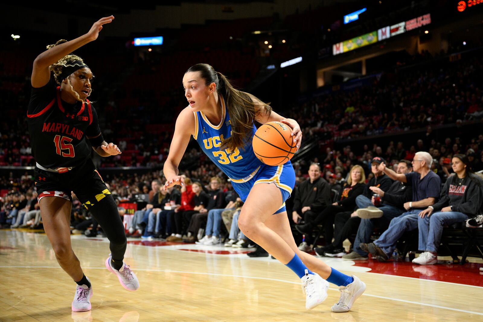 UCLA forward Angela Dugalic (32) drives to the basket against Maryland forward Christina Dalce (15) during the first half of an NCAA college basketball game, Sunday, Jan. 26, 2025, in College Park, Md. (AP Photo/Nick Wass)