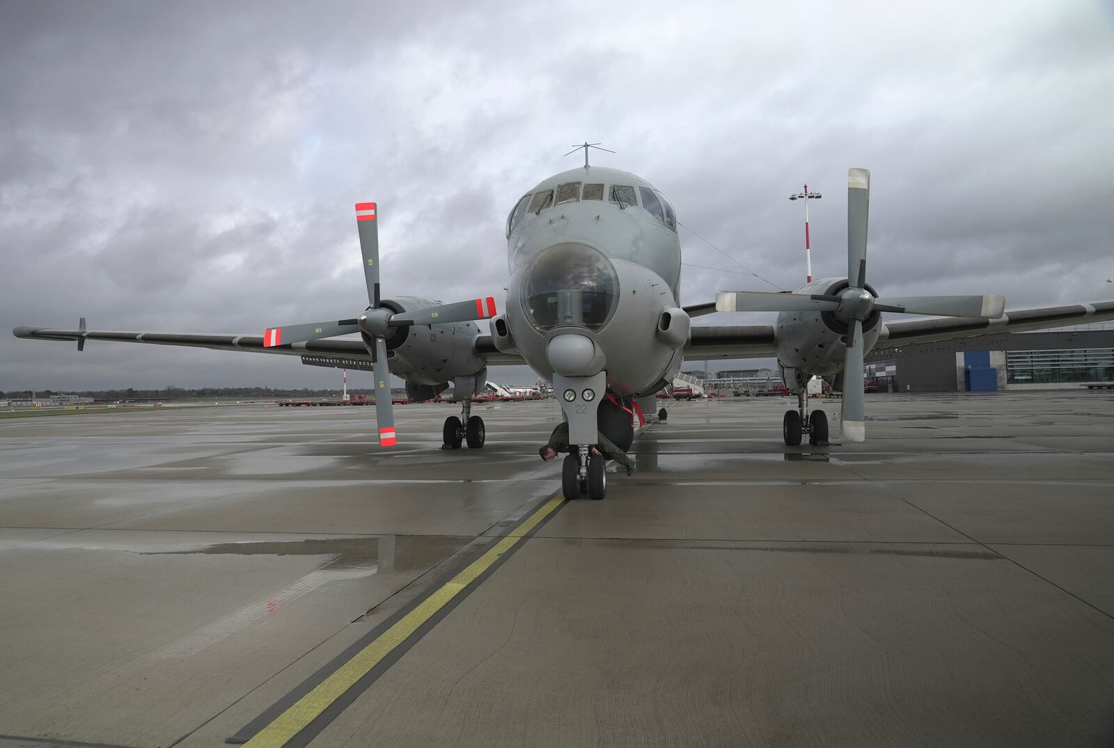 Pilot Lt. Terry (surname withheld by the French military) inspects the wheels of a French Navy Atlantique 2 surveillance plane before its takeoff from Hamburg, Germany, Thursday, Jan. 23, 2025, on a NATO patrol over the Baltic Sea as part of the military's alliance "Baltic Sentry" mission to protect undersea cables and pipelines from sabotage. (AP Photo/John Leicester)