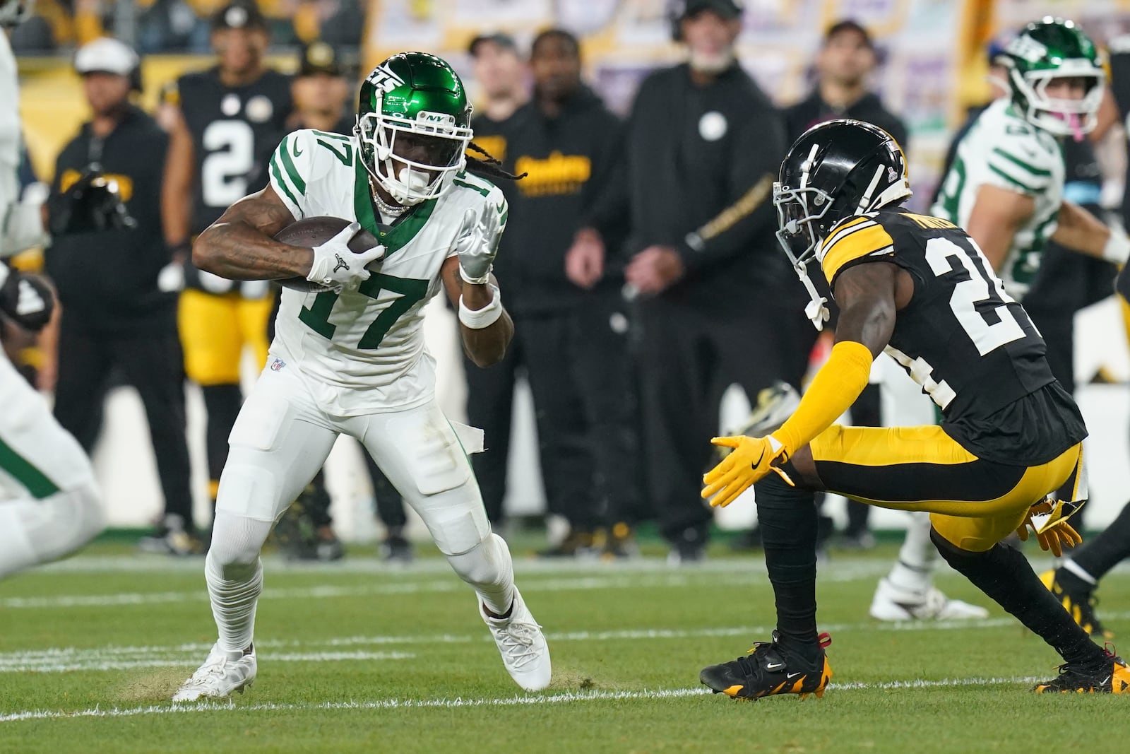 New York Jets wide receiver Davante Adams (17) pulls in a pass reception against Pittsburgh Steelers cornerback Joey Porter Jr. (24) in the first half of an NFL football game in Pittsburgh, Sunday, Oct. 20, 2024. (AP Photo/Matt Freed)