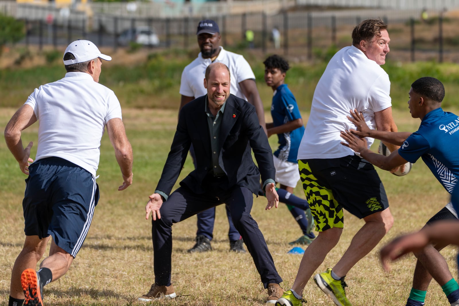 Britain's Prince William plays rugby with pupils at the Ocean View Secondary School in Cape Town, South Africa, Monday, Nov. 4, 2024. (AP Photo/Jerome Delay-pool)