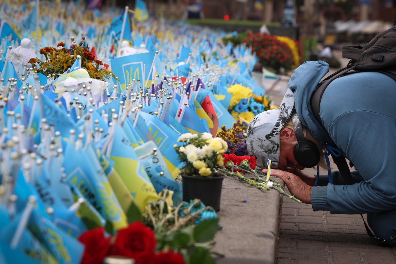 A woman reacts during the All-National minute of silence in commemoration of Ukrainian soldiers killed in the country's war against Russia in Independence square in Kyiv, Ukraine, Sunday, Oct. 1, 2023. (AP Photo/Alex Babenko)