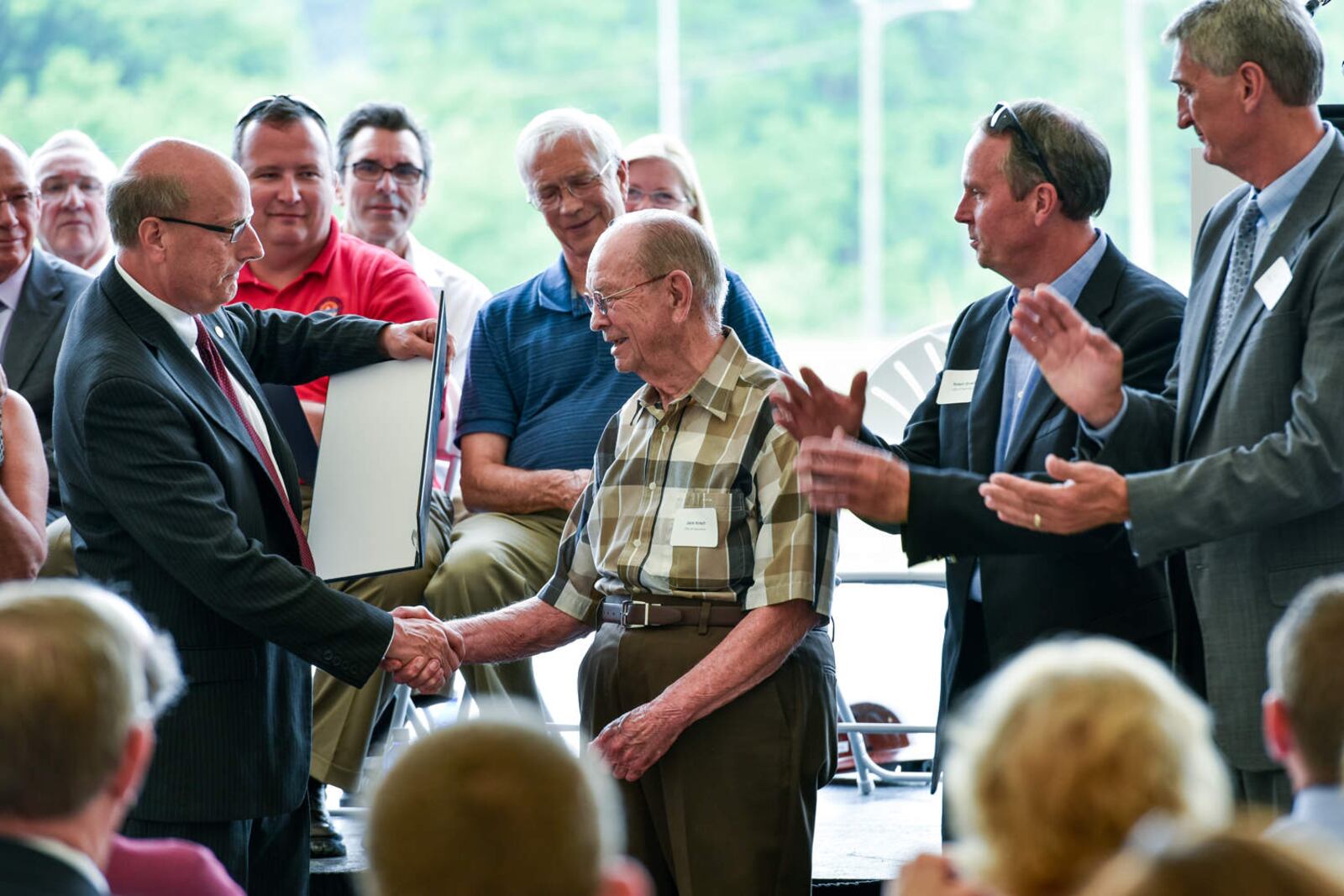 The city of Hamilton and American Municipal Power, Inc. held a dedication ceremony for the 105-MW Meldahl Hydroelectric Plant Thursday, June 2 in Foster, Kentucky. Mayor Pat Moeller presents a proclamation from the city to former city manager Jack Kirsch and other city employees during the ceremony. NICK GRAHAM/STAFF