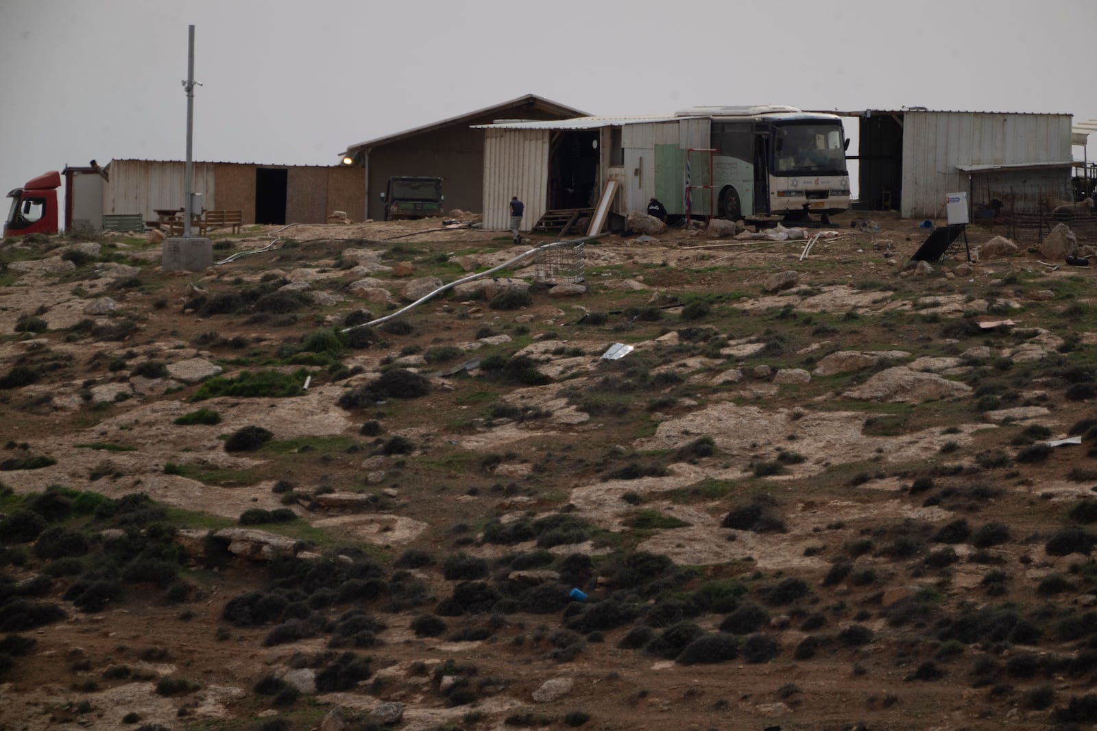 An Israeli settler walks on an outpost near the West Bank village of Tuwani, Monday, March 3, 2025. (AP Photo/Leo Correa)