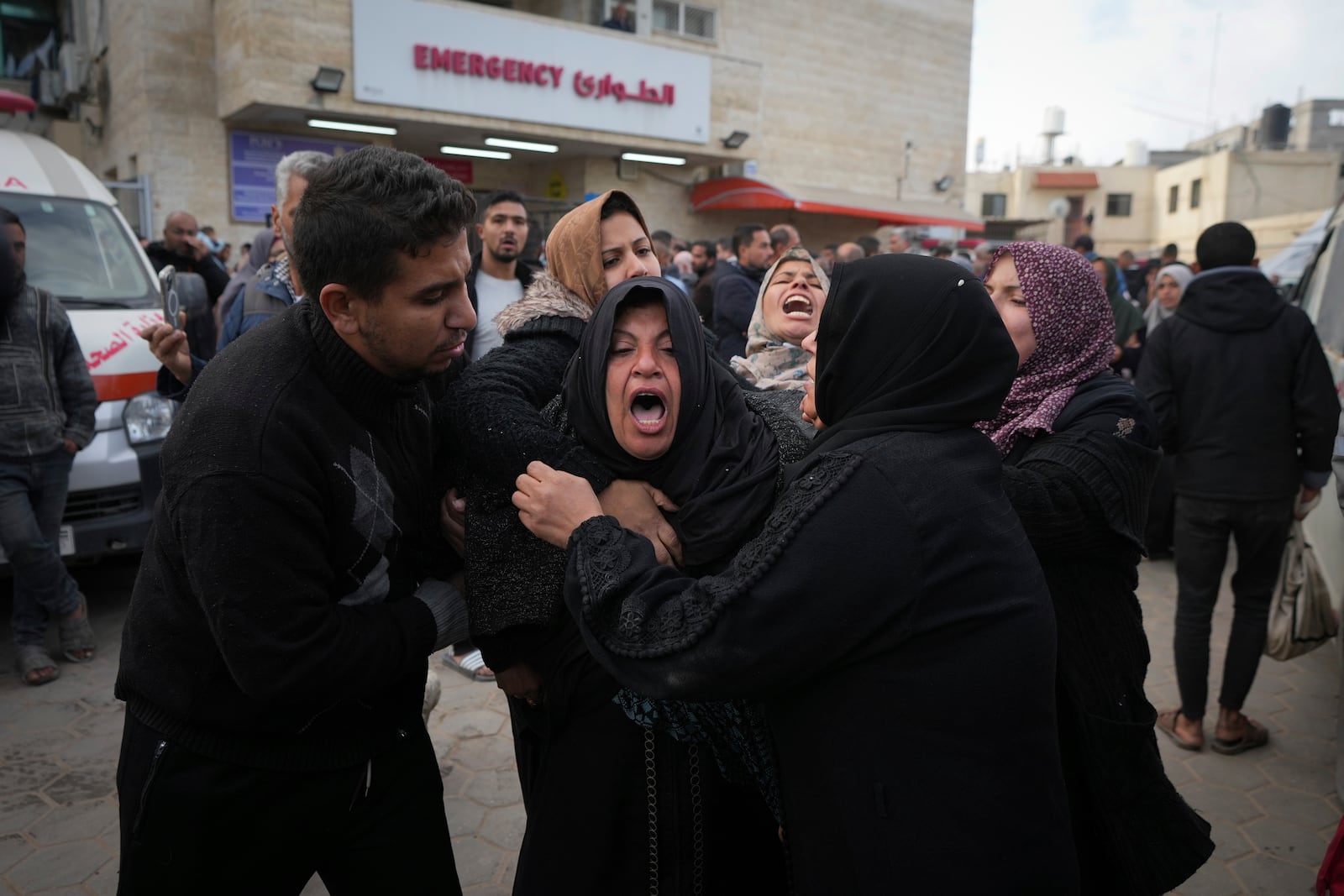 Palestinians mourn their relatives killed in the Israeli bombardment of the Gaza Strip, at Al-Aqsa Martyrs Hospital in Deir al-Balah, Sunday, Jan. 5, 2025. (AP Photo/Abdel Kareem Hana)