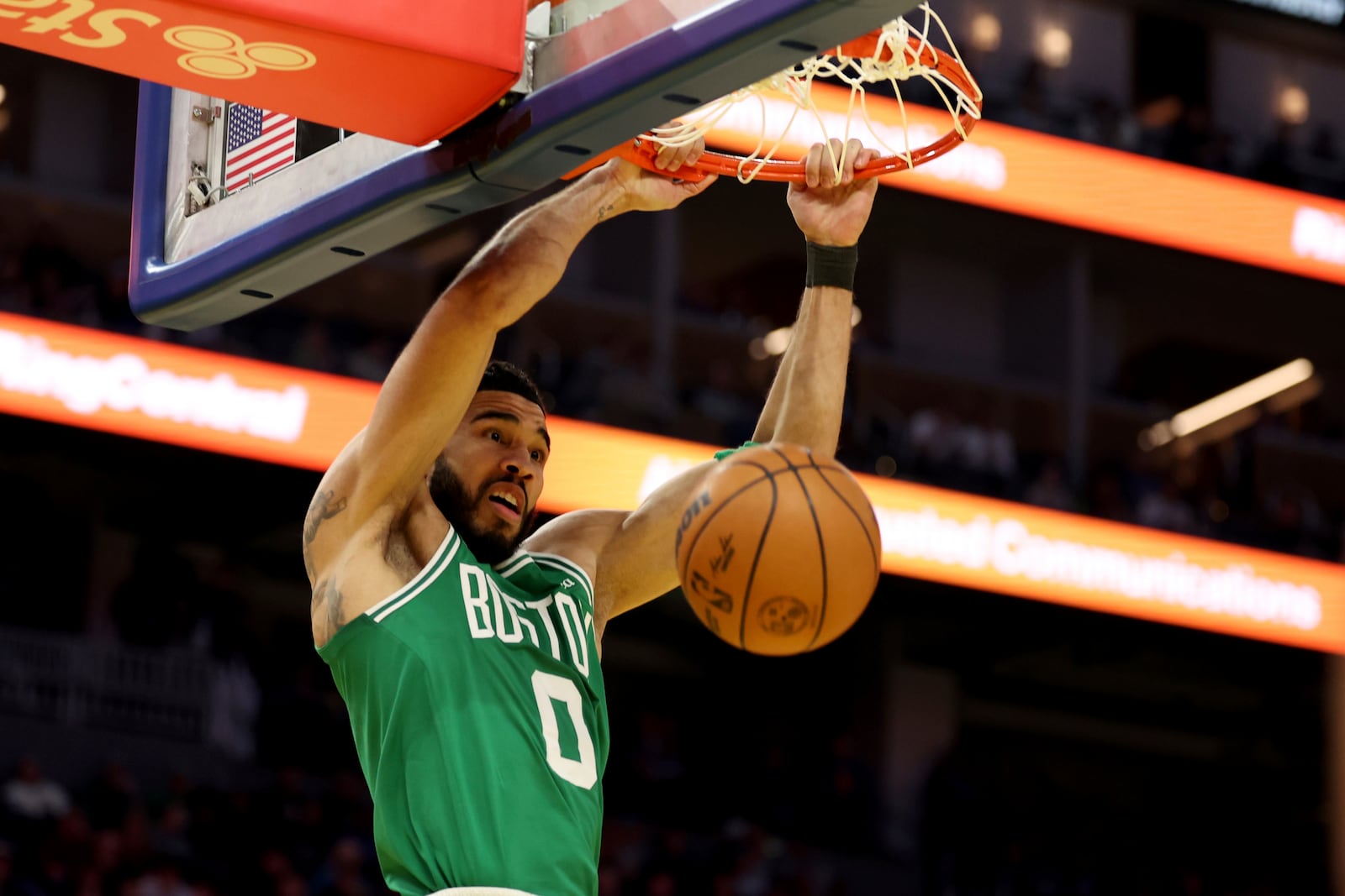 Boston Celtics forward Jayson Tatum (0) dunks the ball during the first half of an NBA basketball game against the Golden State Warriors in San Francisco, Monday, Jan. 20, 2025. (AP Photo/Jed Jacobsohn)