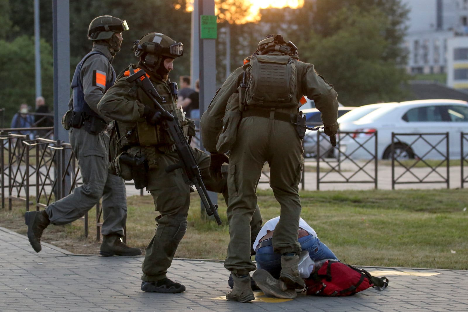 FILE - Police officers kick a demonstrator during a protest in Minsk, Belarus, Aug. 10, 2020, following the disputed presidential election. (AP Photo, File)