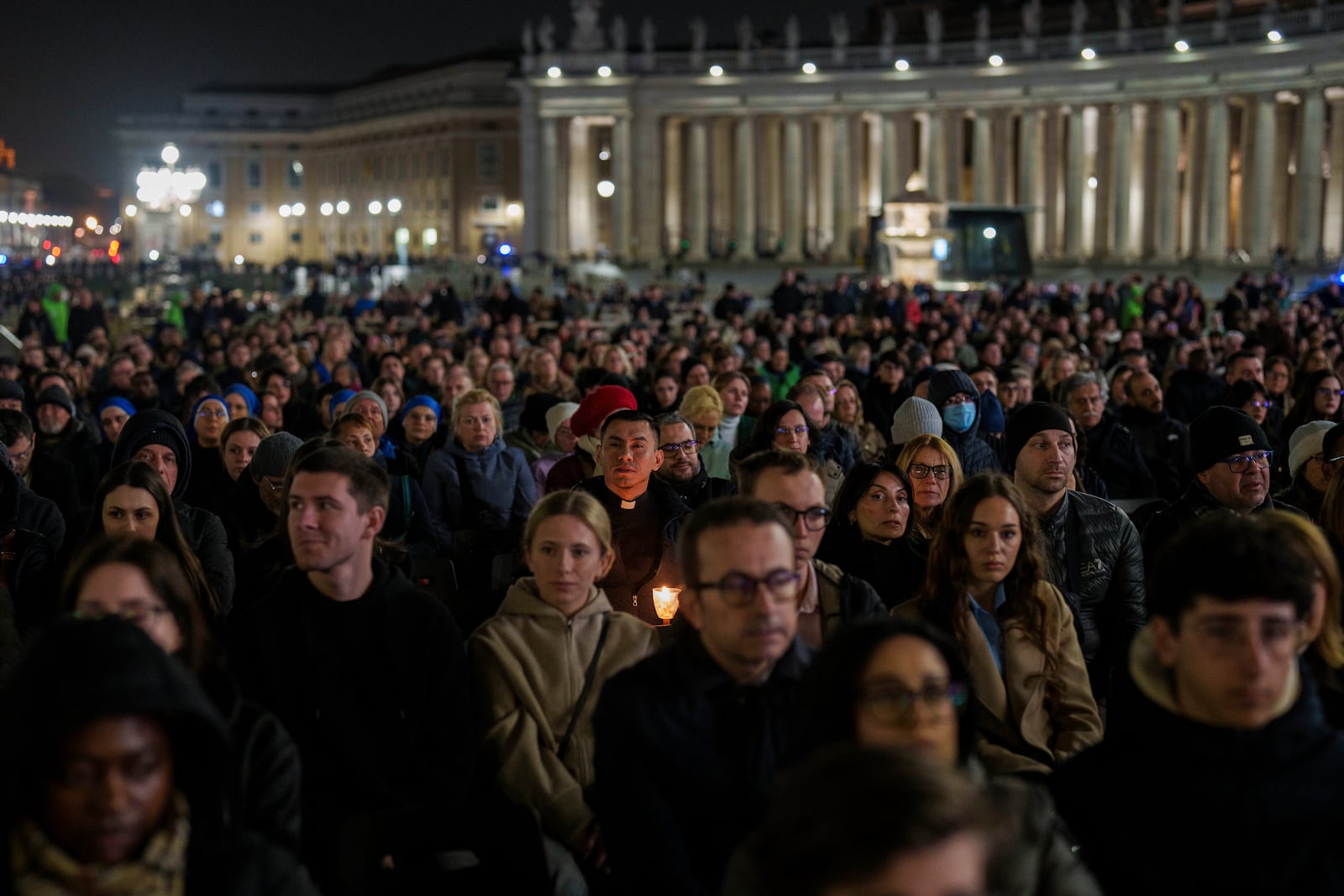 Catholic faithful attend a nightly rosary prayer service for the health of Pope Francis in St. Peter's Square at the Vatican, Wednesday, Feb. 26, 2025. (AP Photo/Bernat Armangue)